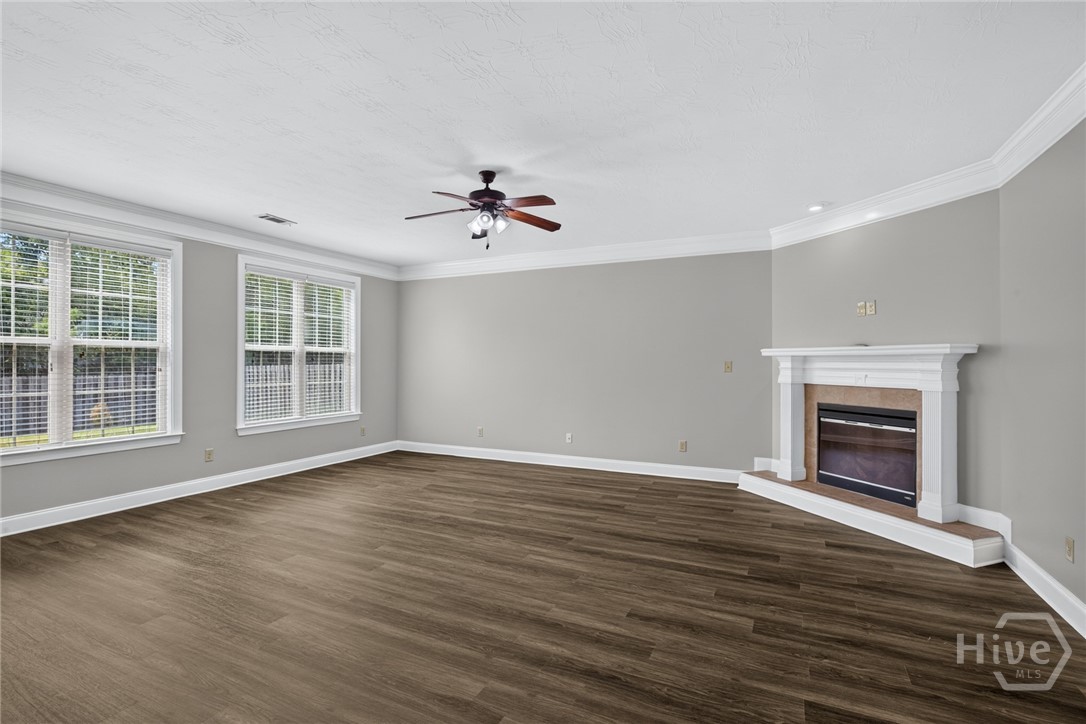 Spacious Family Room with electric fireplace and arched openings to the kitchen