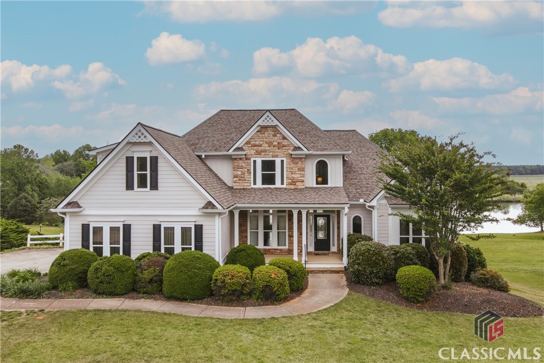 Welcome to 253 Harris Hills—a beautiful lakefront home offering serene views, spacious living, and thoughtful design throughout. As you step through the front door, you’re greeted by a formal dining room on the left and a versatile office or living room on the right. The den features vaulted ceilings, two large dormer windows that fill the space with natural light, and a cozy gas fireplace.The expansive primary suite includes tray ceilings, private access to the back deck, and stunning views of the lake. The en suite bath is a retreat of its own, featuring vaulted ceilings, dual vanities, a jetted tub, a separate shower, and a generous walk-in closet.The kitchen is filled with natural light and offers granite countertops, custom cabinetry, under-cabinet lighting, and a charming seating area overlooking the water. Step directly onto the back deck to enjoy morning coffee or sunset dinners with a view. Off the kitchen, you’ll find a spacious laundry room with ample storage.Upstairs, there are three additional bedrooms and two full baths. Two bedrooms share a hallway bath with double vanities, while the third bedroom enjoys its own private en suite.The partially finished basement adds incredible flexibility with LVP flooring, a bedroom with built-in bookshelves, a full bath, and a den with a kitchenette—perfect for guests, an in-law suite, or entertaining. A screened porch off the basement offers another peaceful spot to enjoy the outdoors, and there’s plenty of unfinished space for storage. There is even a peach tree and blueberry bushes on the property that yield fruit each year!Recent updates include a new roof, new hot water heater, and fresh exterior paint in 2024. This meticulously maintained home is move-in ready—schedule your showing today!