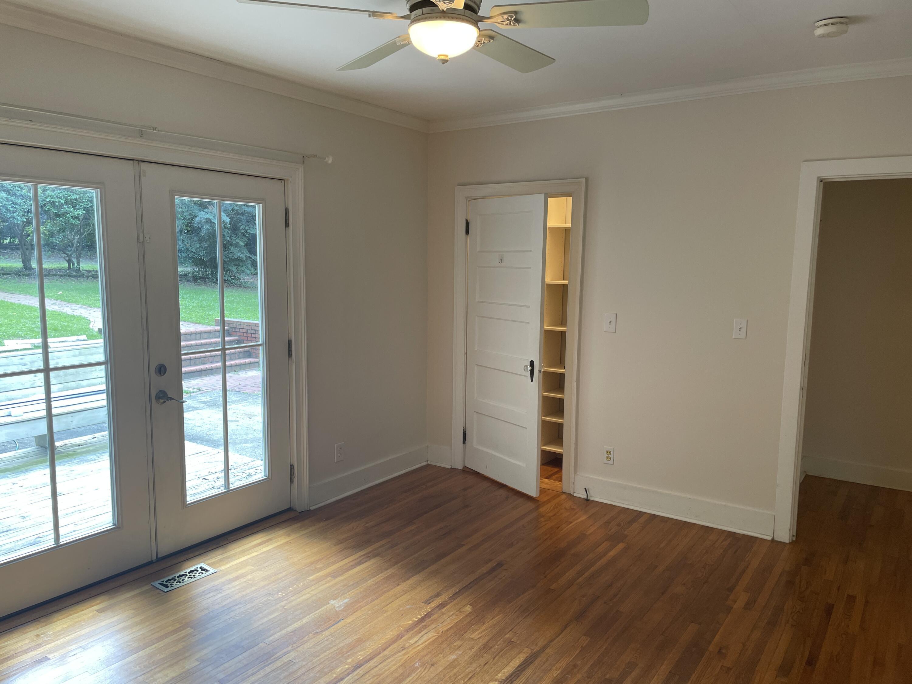 PRIMARY BEDROOM WITH FRENCH DOORS LEADING ONTO DECK