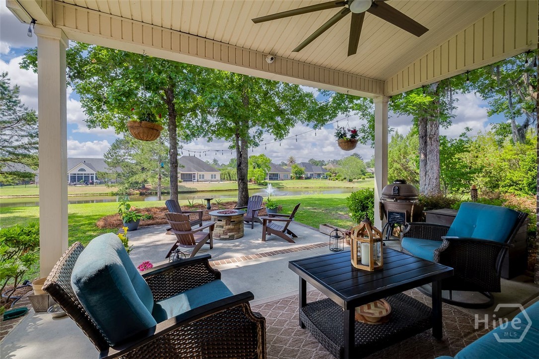 Large patio both covered and uncovered. Speckled shade adds more comfort throughout the day. New fan added to the porch