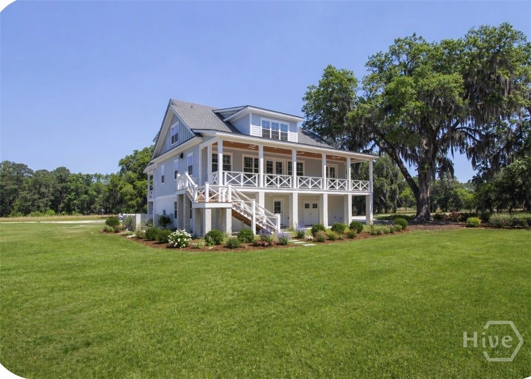 Rear of the home… Covered porch all the way across coming off the kitchen and Great room to enjoy your beautiful big yard!