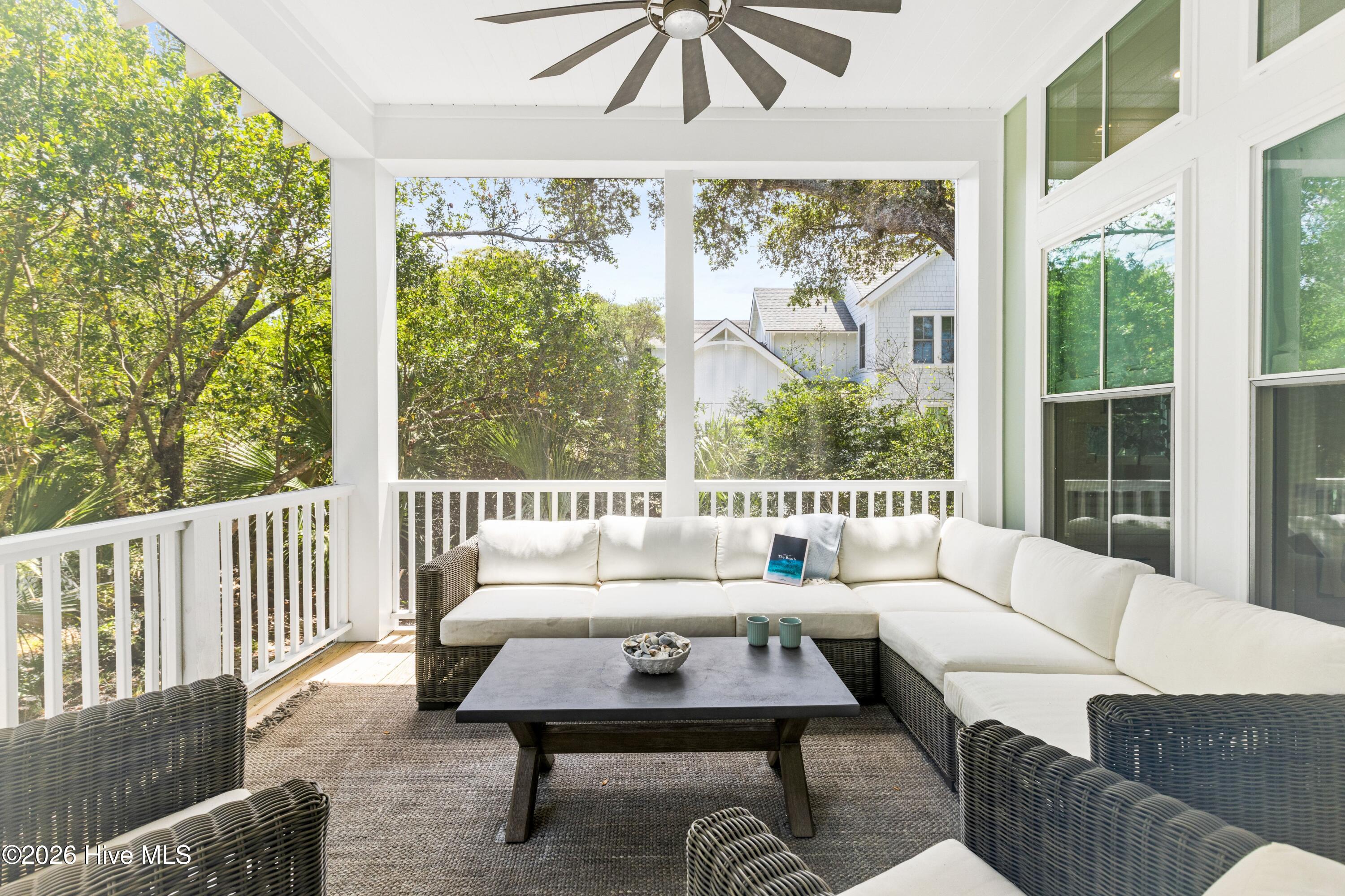 Screened-in porch with dining and seating areas