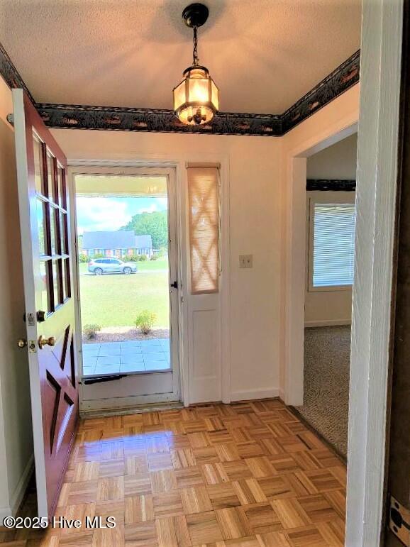 Entry with lovely parquet flooring