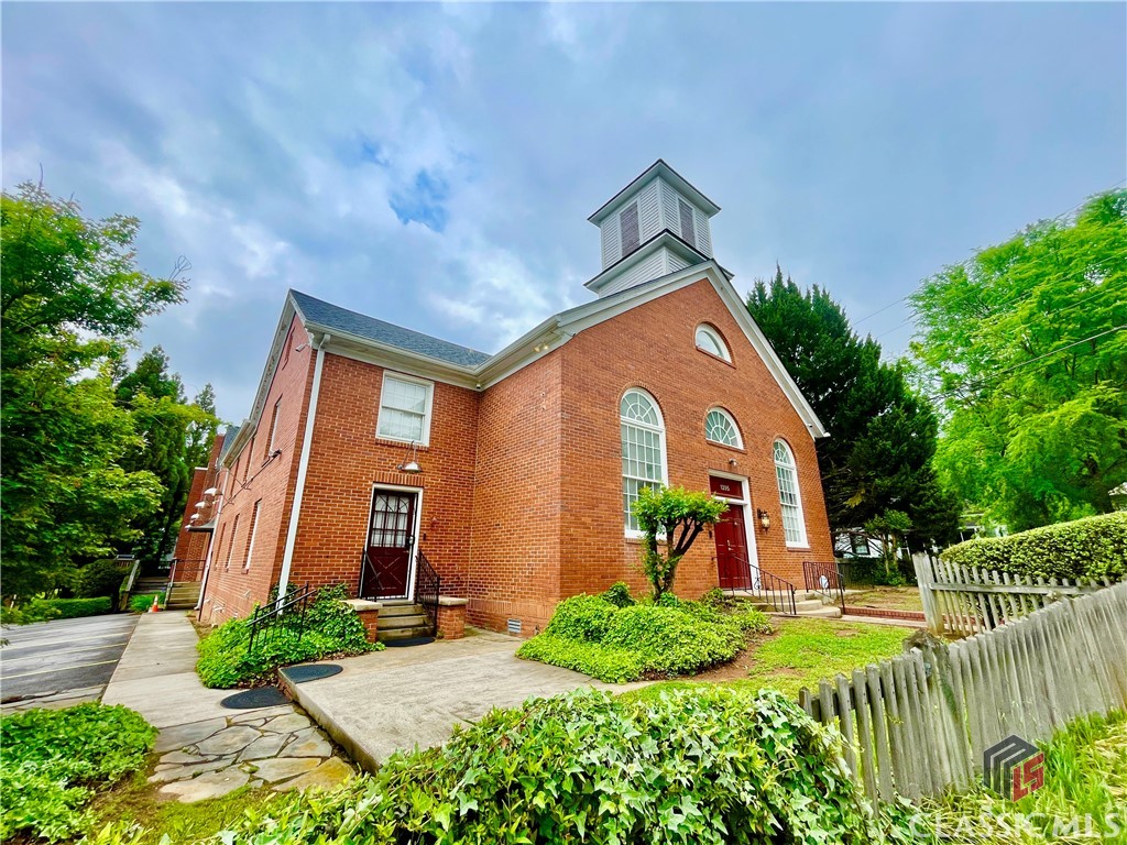 Live in one of Athens' most unique places - a converted 1800's church in the heart of Chicopee Dudley. With over 1700 Sq.Ft.,this loft style 2 Bedroom / 2 Bath condo has everything that you need. High ceilings, a bathroom for each bedroom and an open floor plan. Also a great private patio, the largest in the building, that gives you your own entrance to your unit, while a security code gets you into the building. Once you enter the unit you will immediately notice brick wall accents and all the natural light that the wall of windows offers. The kitchen is open to the living room and dining area for easy entertaining, complete with a bar counter top and stools. The main floor also features a large bedroom with a huge walk-in closet, bathroom and laundry room. The upstairs loft overlooks the lower level and shares all the natural light from the windows and skylight. The loft area would be ideal for a 3rd room, or office area or just a nice entertainment area. The private master bedroom is upstairs with a large walk-in closet and bonus area. The master shower is quite large, featuring shower heads at either end and is ready for you to enjoy. The bonus area would be perfect for early morning yoga or a small office. A new toilet, bathroom sink & faucet and a new dishwasher installed in the kitchen. The building door uses a code or key and the front door does the same - you don't even need to hold keys in your pocket! There is a separate storage area in building 100. UGA Chicopee Shuttle runs from the parking lot N01 (a 2-3 minute walk from the condo) to the main library on campus every day M-F until 6:30pm. Located within blocks of shopping and dining, down the street from the Greenway and Firefly trails. Walker Park featuring a water park, playground, biking trails and soccer fields (formerly Trail Creek) and Dudley Park. Don't let this condo slip out from your fingertips.