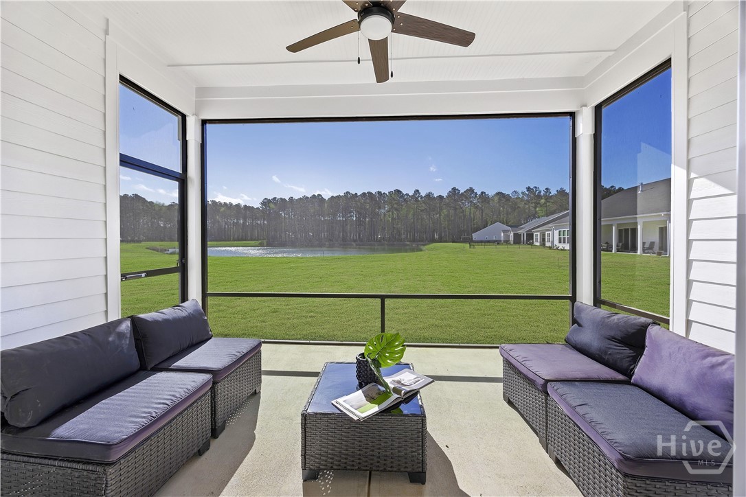 Screened porch overlooking the lagoon and natural treeline backdrop