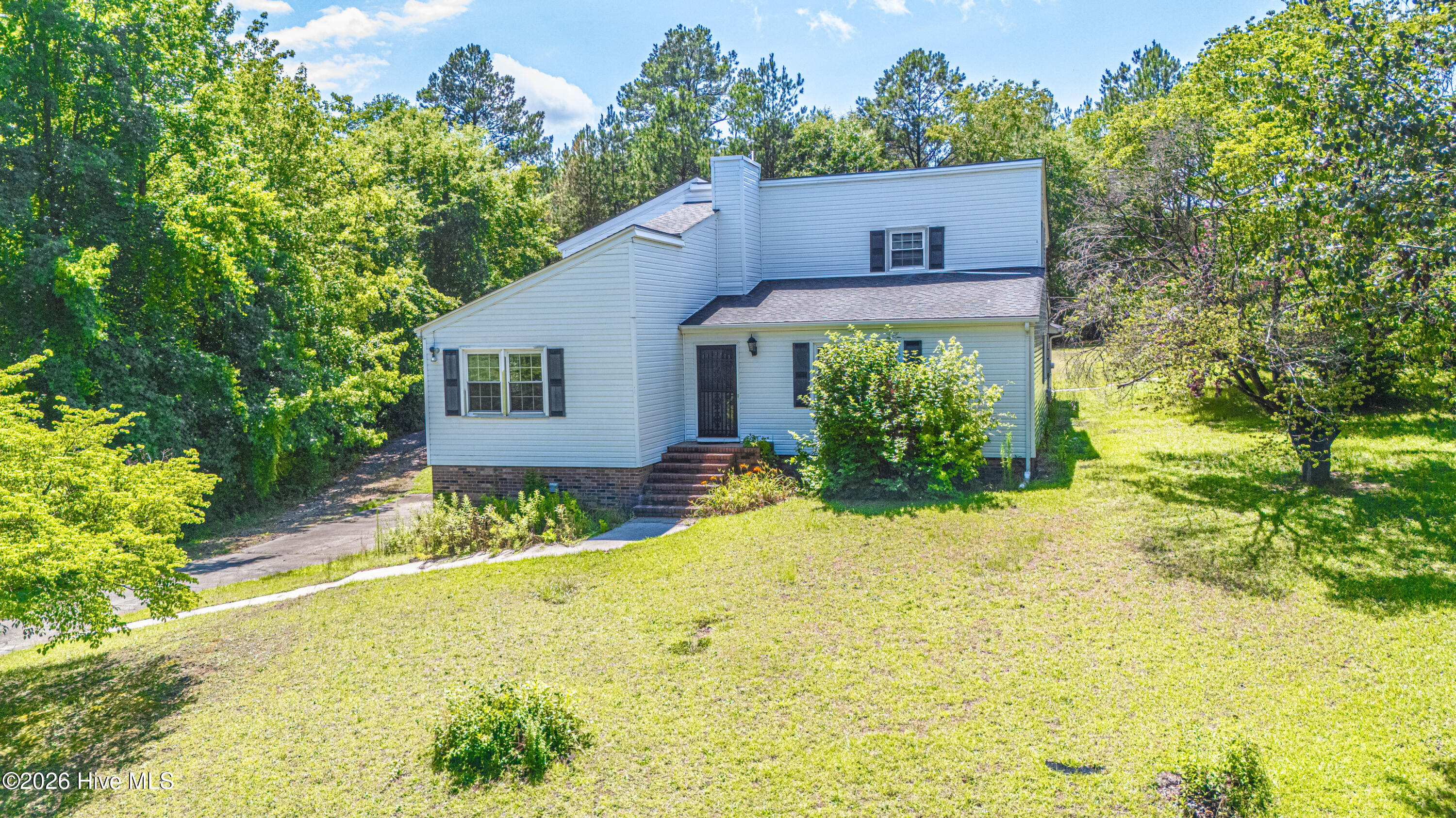 Tucked away on a quiet road just outside the city limits, this spacious two-story home on 2 acres offers the perfect combination of privacy and convenience, with easy access to everything Rockingham has to offer.Featuring 4 bedrooms and 3 full bathrooms, the thoughtfully designed floor plan includes a main-level primary suite with a private bath, plus an additional guest bedroom and full bath on the first floor. Upstairs, you'll find two more generously sized bedrooms, including one with its own private balcony overlooking the property.The updated kitchen is designed for both everyday living and entertaining, showcasing white shaker-style cabinetry with new cabinet fronts, a center island, granite countertops, double ovens, glass cooktop, and ample workspace.The finished basement adds exceptional flexibility with heated and cooled bonus rooms, abundant storage, an attached garage, and additional spaces perfect for a home office, recreation room, gym, or hobby area.Step outside to enjoy your own private retreat featuring covered carport, 20x40 inground chlorine pool that is 12ft deep with diving board, new pool pump and 3 year old liner, BBQ area next to the patio, attractive brick fencing, a concrete driveway, and mature landscaping that provides an impressive sense of privacy.If you've been searching for room to spread out in a peaceful setting without sacrificing convenience, 118 Pirate Lane is ready to welcome you home.