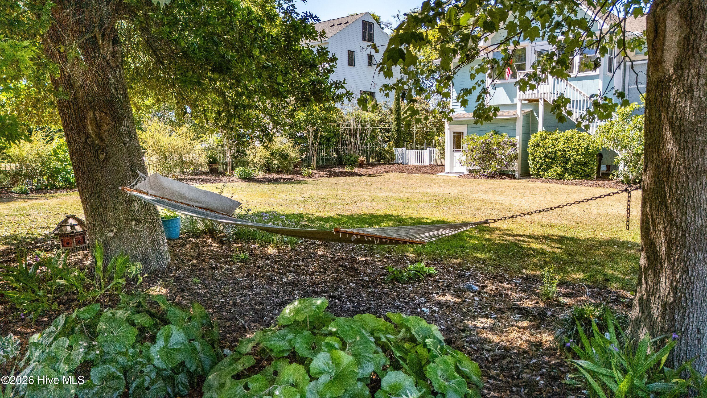 Huge fenced in yard complete with raised beds and all beautiful mature landscape ,rain barrels , green and natural!