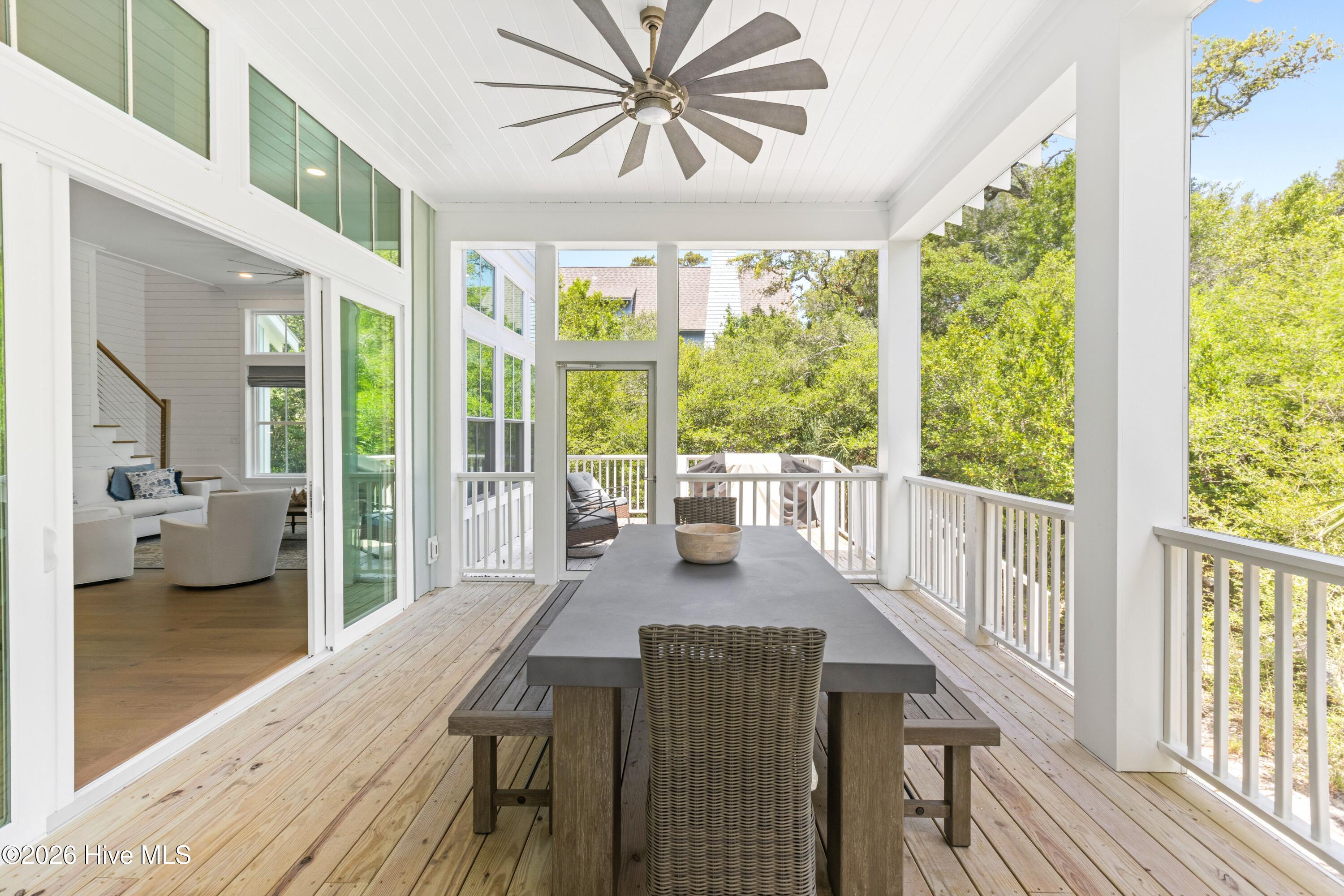 Screened-in porch with dining and seating areas