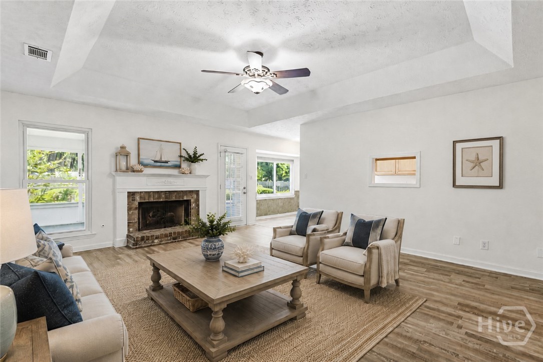 The living room has been virtually staged to show you how it would look with furniture and decor.