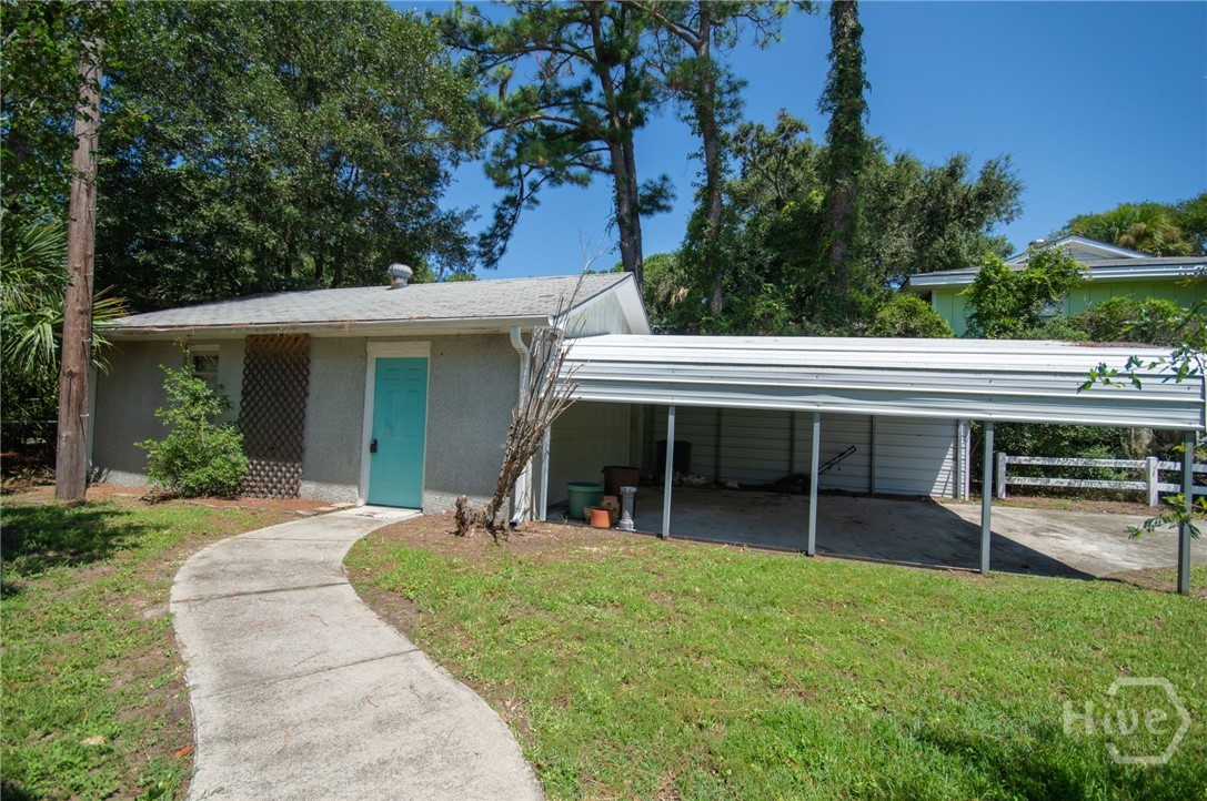 Carport and garage offers plenty of storage for golf cart, lawn equipment, bikes and beach toys.