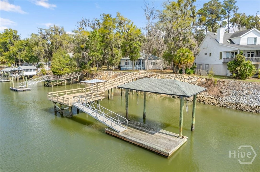View from the water of walk, dock, ramp and covered boat hoist.