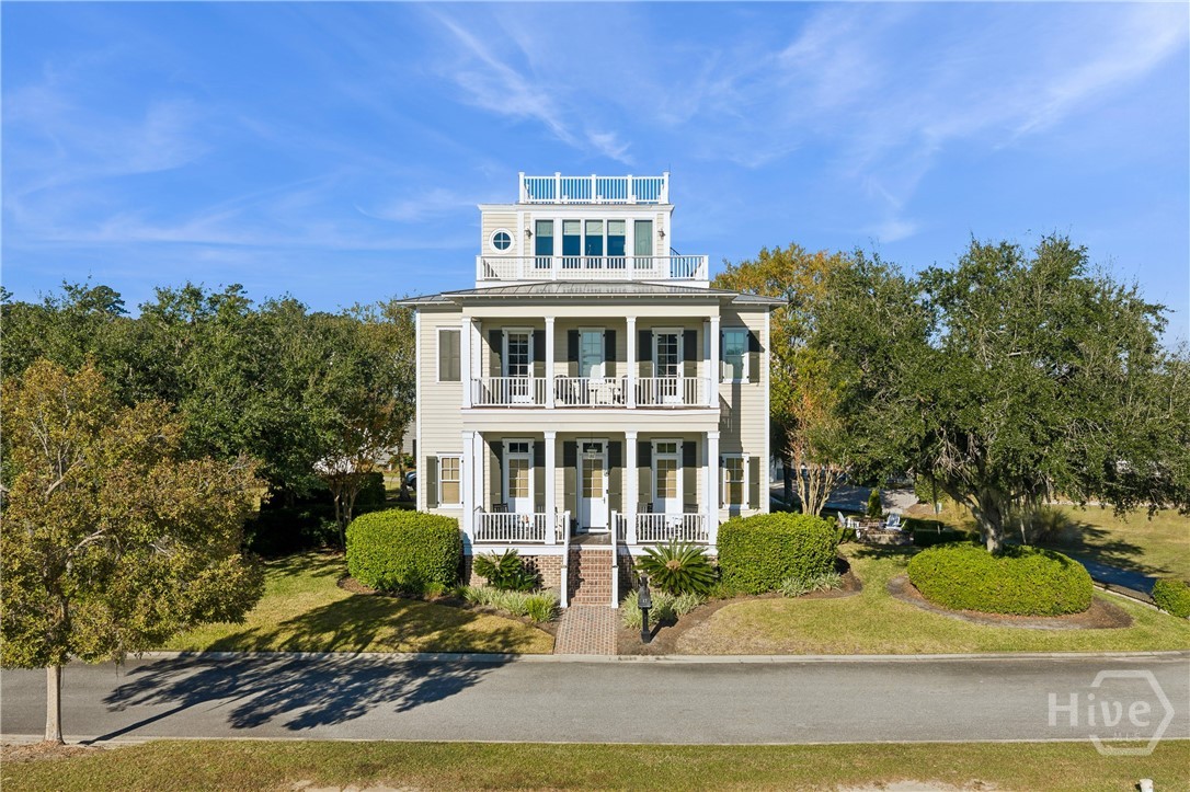 Exceptional Opportunity at 17 Riverview Drive. Nestled within the coveted Silk Hope Harbor enclave of The Ford Field & River Club, this 3,172 SF three-story retreat blends timeless Lowcountry character with refined modern living. Featuring 4 bedrooms and 4.5 baths, the home showcases a copper roof, traditional captain’s walk, and sweeping views over Lake Clara toward the winding Ogeechee River. Inside, an open, sun-filled layout highlights a gourmet kitchen with exposed beams, high-end appliances, and an expansive center island, all complemented by mahogany floors and custom millwork. Double-stacked porches capture river breezes, while the screened porch—complete with a fireplace—offers an inviting year-round gathering space. A private brick courtyard with a firepit completes this coastal haven, set just moments from Ford’s world-class amenities.