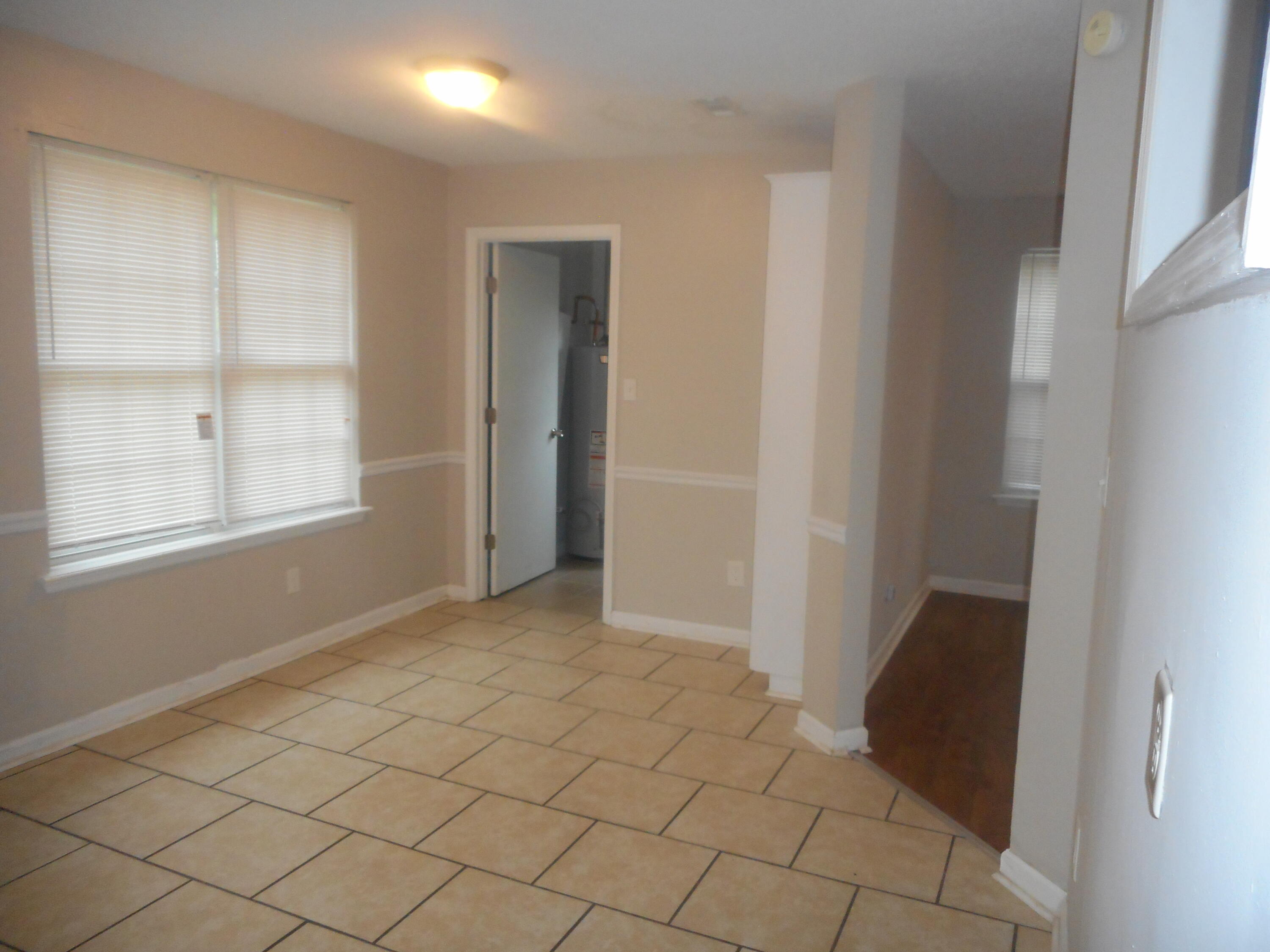 Ceramic tile flooring in kitchen with separate laundry room