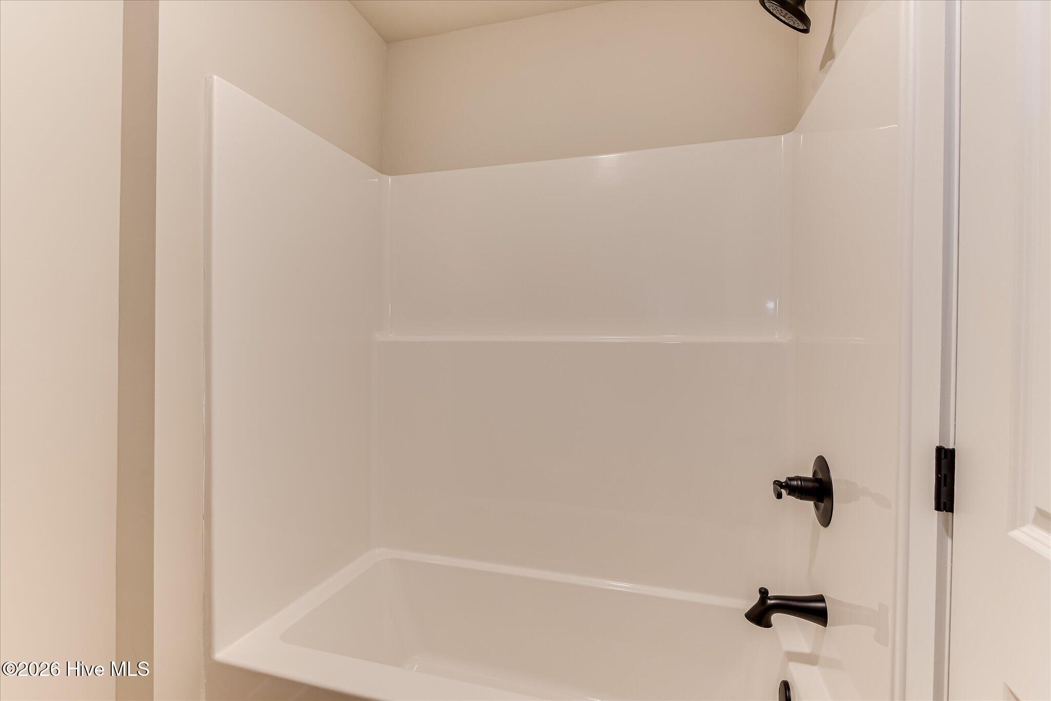 Large, full bathroom with granite countertop, double-sink vanity, tub/shower combo is upstairs.