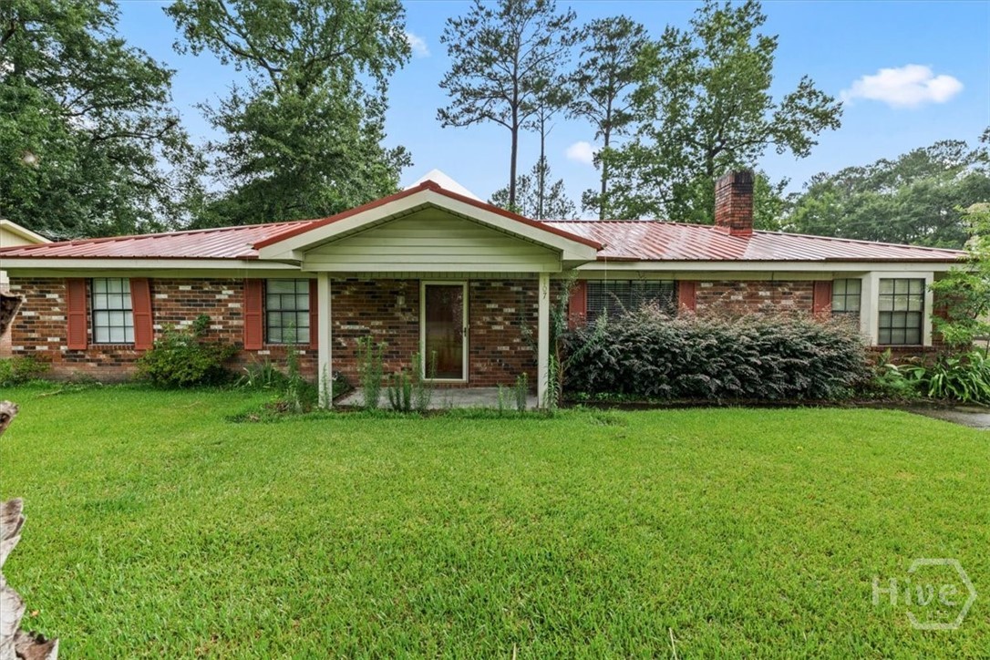Located in the heart of Rincon, this ranch-style brick home has three bedrooms, two full baths, a large living room with a brick fireplace, a bonus room, and it has LVP and tile flooring throughout.  The property also has an outside workshop with roll down door and a he/she shed.  This great find is ready for your loving touch.  Motivated seller.  Property sold as is.