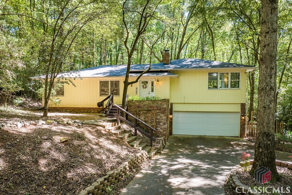 Nature is calling! Check out this unique home sited on a wooded, cul-de-sac lot! Enjoy watching the deer and other wildlife from the expansive rear deck which is accessible from the Primary Suite, kitchen, and breakfast nook. Bright living areas were recently painted and have tons of windows overlooking the private yard. The updated kitchen features newer stainless steel appliances, two skylights, and plenty of cabinet space. A spacious Primary Suite is complete with a walk- in closet and updated bathroom with tiled shower. Two additional bedrooms on the main level share a spacious hall bathroom. The basement level offers additional living and storage space, plus a fourth bedroom with full bathroom. There is also a large laundry room, and the two car garage is accessible nearby. Other major bonuses include a new roof (2022), new water heater (2023), and new HVAC (2019). University Heights is one of Athens, Georgia’s hidden gems on the banks of the North Oconee River. Enjoy walking trails, easy access to bike lanes, and close proximity to the University of Georgia’s Veterinary Teaching Hospital. Publix, Kroger, and a plethroa of dining options are just a mile down the road!