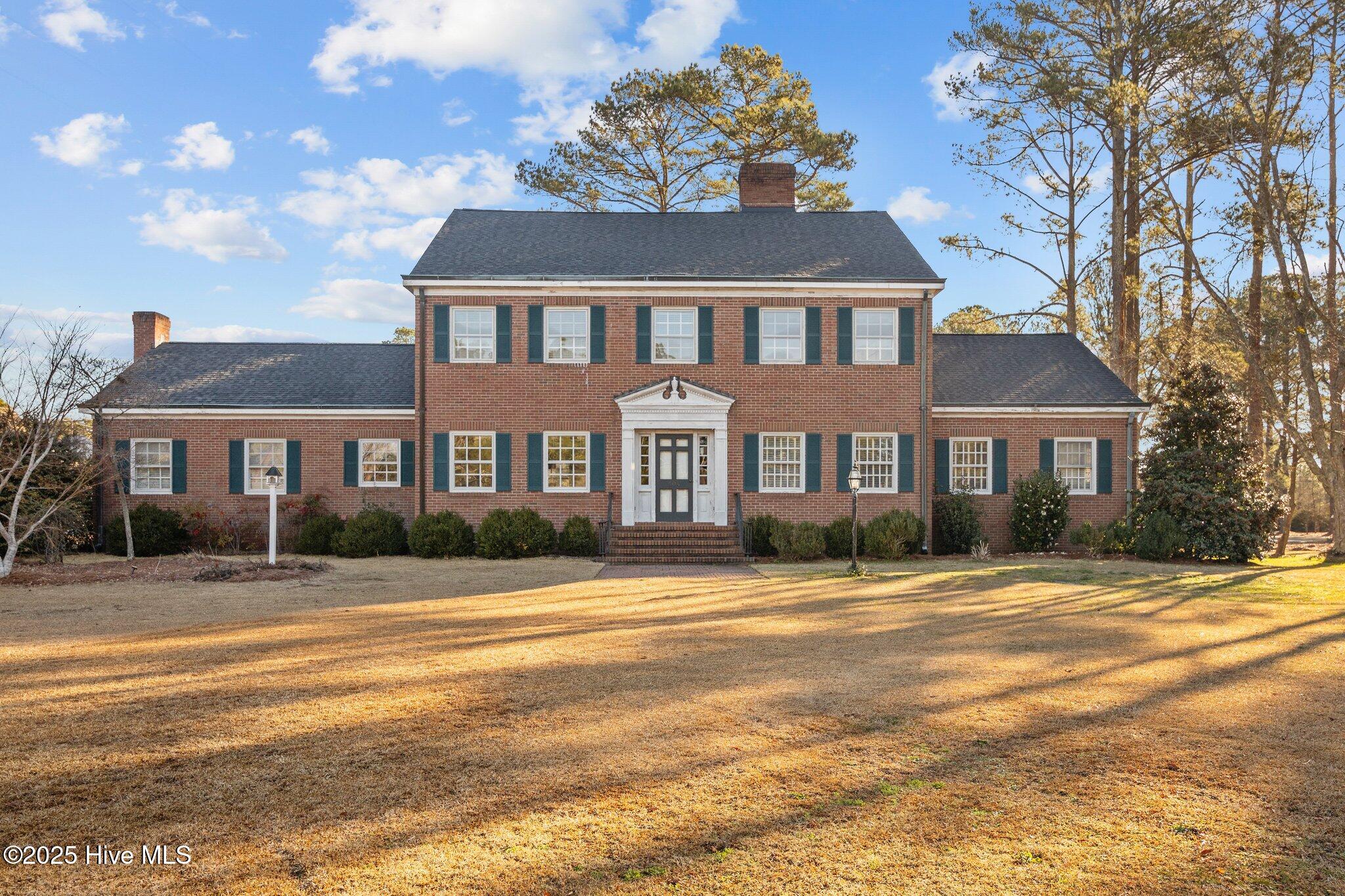 Welcome to your dream home! This stunning large brick residence is nestled in the peaceful small town of Robersonville, offering a perfect blend of comfort and style. Step inside to a beautiful foyer that sets the tone for the rest of the home. A stunning staircase leads to the upper level, making a striking impression. This home boasts five spacious bedrooms, providing plenty of room for family and guests. The master bedroom is conveniently located on the main floor and features a master bath equipped with a walk-in shower and double vanity. Host gatherings in the elegant formal dining room, perfect for entertaining or enjoy casual meals in the charming breakfast nook bathed in natural light. Stylish built-ins throughout enhance the home's functionality and aesthetics. A dedicated office space makes work or study a breeze. 
 Relax in the den featuring gorgeous wood paneling, adding warmth and character.  Ample outdoor space on a large lot, ideal for gardening, play, or relaxing. Screened porch is perfect for sipping morning coffee or evening gatherings while enjoying the fresh air. A large driveway provides plenty of parking space, along with a convenient double carport that includes extra storage. Additional storage space can be found in the basement. Peace of mind comes with a roof that is only two years old. This beautiful home with traditional charm, makes it a perfect fit for families looking for space and comfort in a welcoming southern town. Being sold as is but with some cosmetic touches and updates it could be a showstopper!