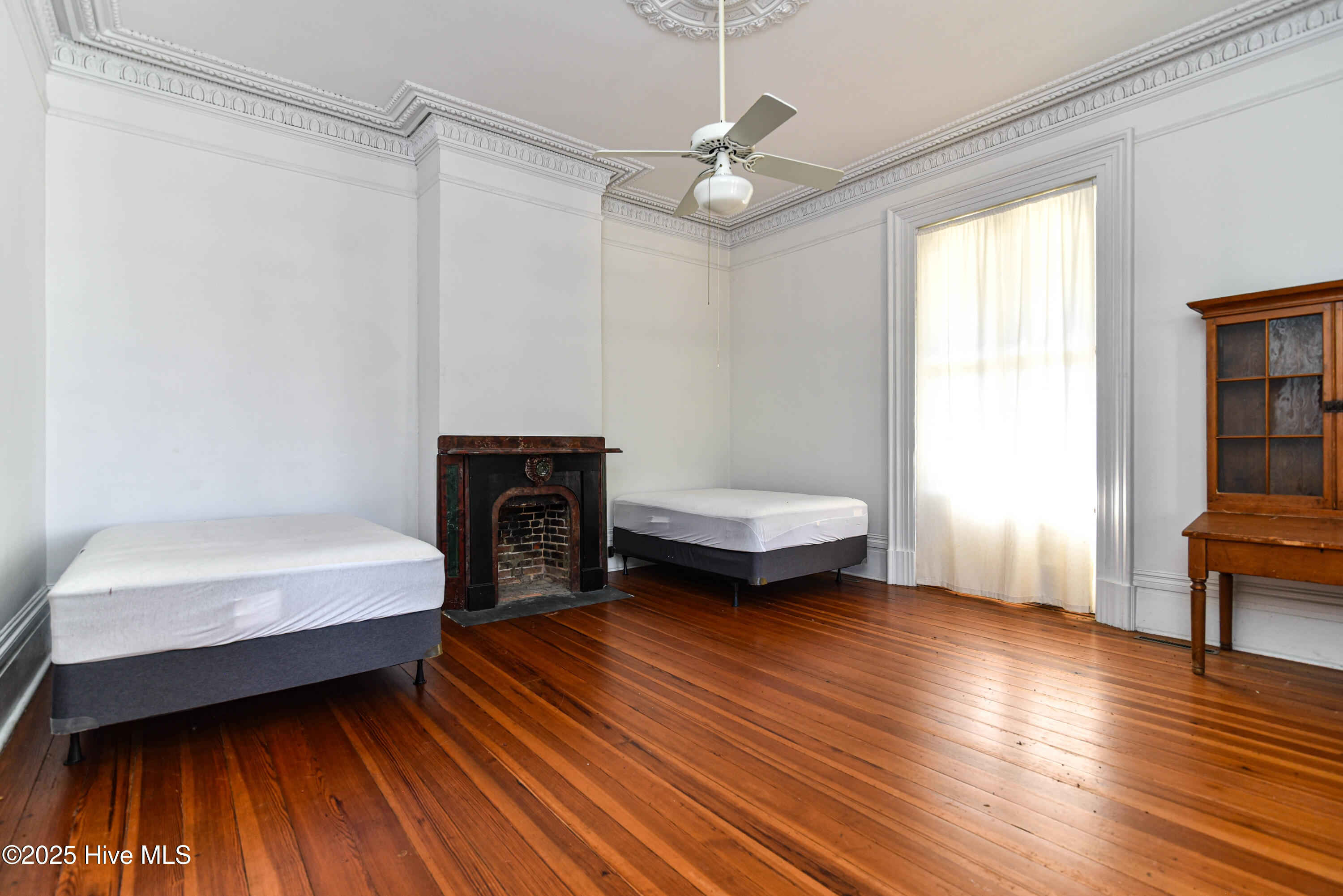 Front right sitting room. Curtain is hiding 9' tall original pocket door.