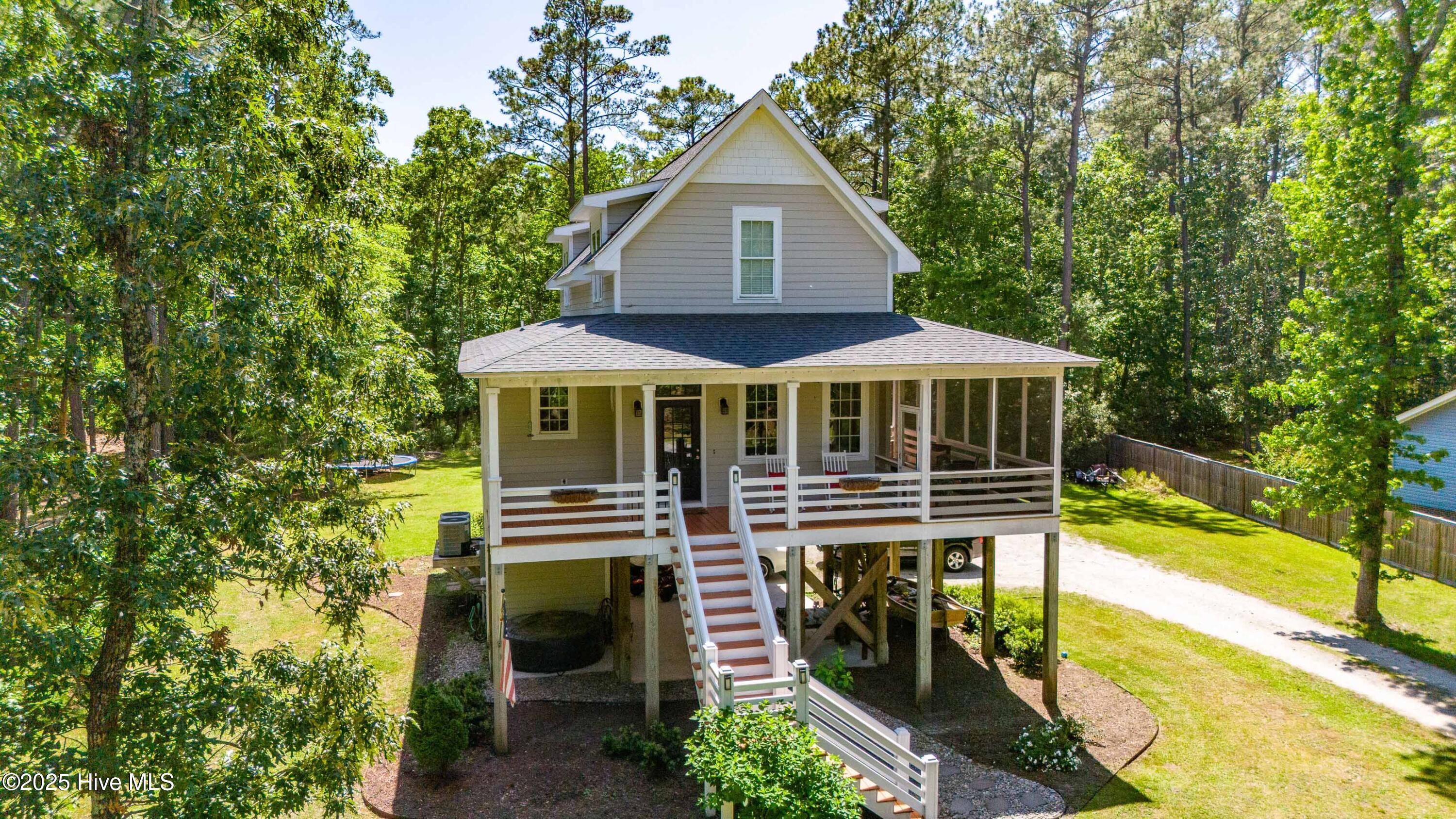 61 Spinnaker Point Road N Oriental, North Carolina Elevated, 3 Bedroom/2.5 Bath home in the Spinnaker Point community with deeded boat slip. Beautiful custom-built home features and open floor plan, covered front porch, bamboo and tile floors, fireplace, and granite counters. Quality materials and workmanship evidenced in the construction of this immaculate home include cement board siding, architectural shingles, and beautiful finishes. Concrete slab underneath generously accommodates two cars and other outdoor necessities. Covered porch and screen porch invites you to enjoy the outdoors. Situated on nearly an acre of beautifully manicured and landscaped lawn, this home is only a ten minute drive to the Village of Oriental and moments from the Neuse River and ICW.