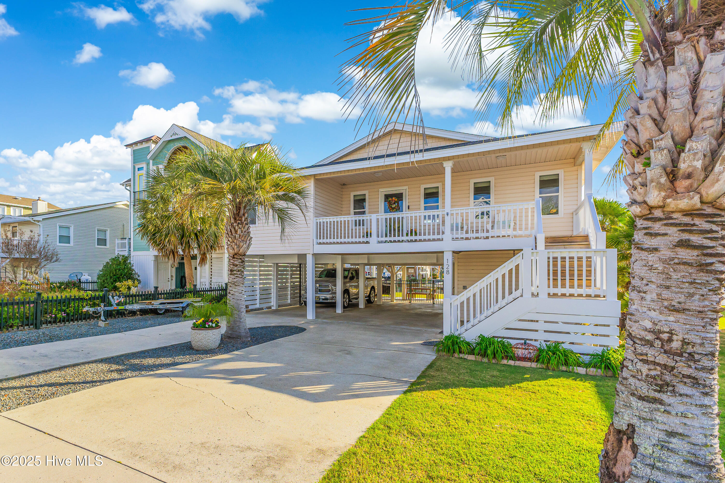 Dive into coastal living with this show-stopping waterfront retreat—nestled on a deep-water canal and mere moments from the sun-kissed shores of Holden Beach! Love boating? Cruise straight from your private boat lift and dock out to the Intracoastal Waterway for sun-soaked adventures. Beach lover? Quick and easy access means your toes are in the sand in no time! Public beach access and parking are just around the corner—but you can leave the car behind, because the shoreline is an easy stroll from your front door!This home is all about easy, breezy coastal living—with big-ticket updates already done for you! Rest easy—this home has been lovingly cared for and thoughtfully upgraded over the past 15 years! In just the last two years, the owners have invested in a brand-new seawall, dock, floating dock, and a 10,000 lb boat lift. They've also replaced the front door and kitchen windows, updated the electrical panel, painted the exterior, reinforced the pilings, and topped it all off with a fortified roof in June 2025. No surprises—just easy, low-maintenance beach living. Check out the full list of improvements in the images!Move right in—this gem comes mostly furnished (with just a few exclusions)—and start making memories whether you're looking for a forever home, a vacation getaway, or a high-earning short-term rental. The spacious canal-front lot is perfect for grilling, fishing, or simply relaxing and soaking up those stunning water views.Don't let this rare Holden Beach treasure slip away! Schedule your private tour today and discover the perfect blend of boat life, beach days, and pure coastal fun—all from your own backyard!