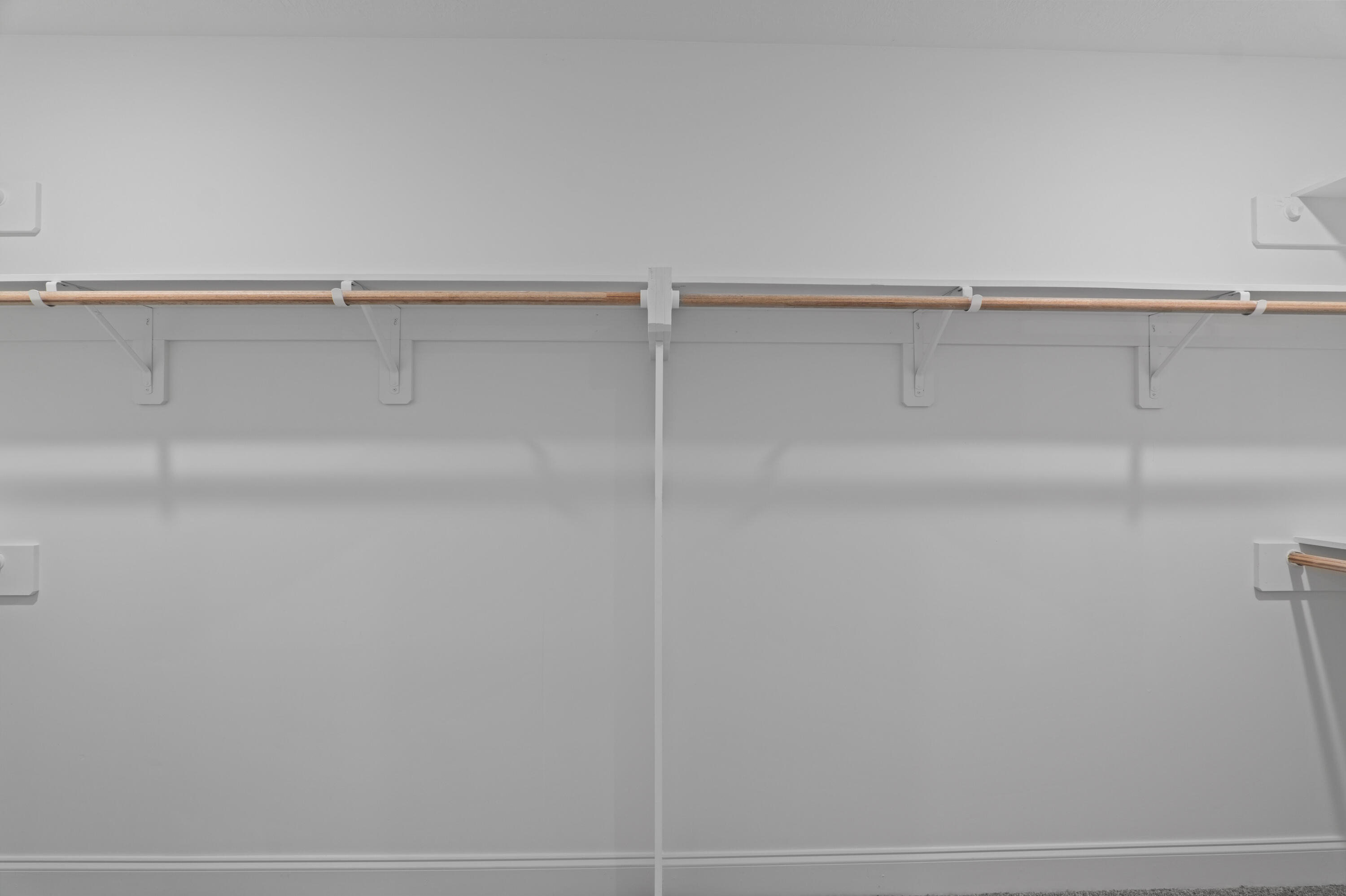 Primary Closet with Wood Shelving