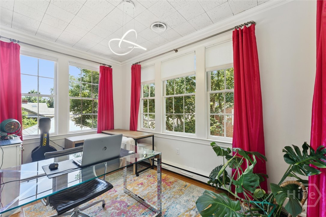 This spacious home office w/ three sets of windows