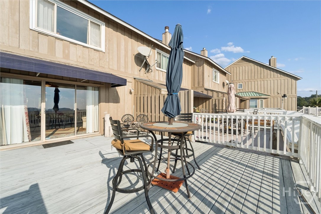 The large deck is just outside the downstairs living area.  It overlooks the water and community dock.  The back of the building has been painted to match the front.