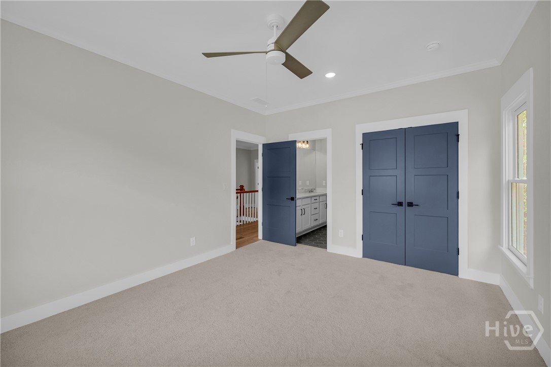 Neutral tone carpeting complements light gray wall paint