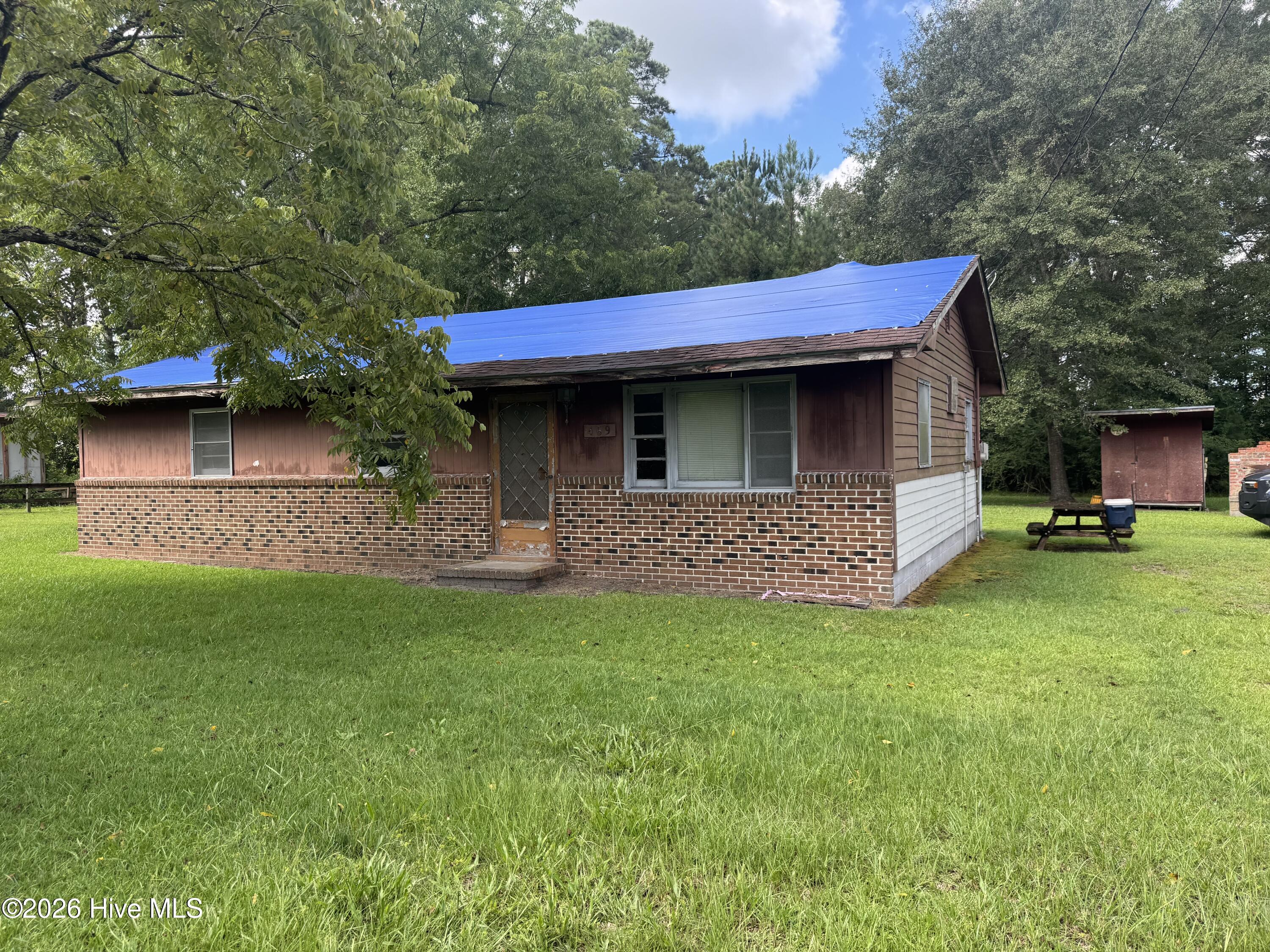 This property is ready for a complete transformation.  A fabulous location in the heart of Pamlico County, Out of the flood zone in Grantsboro, just down from the main intersection of Hwy 306/Hwy 55.  On two combined lots of an acre plus of land., with mature trees and a circular drive. So many possibilities.  Fix up this home and rent out or move in and then build your dream home on the back of the property with privacy in between.  Property is as is and financing may not be available as gas logs are the only source of heat and no cooling system.