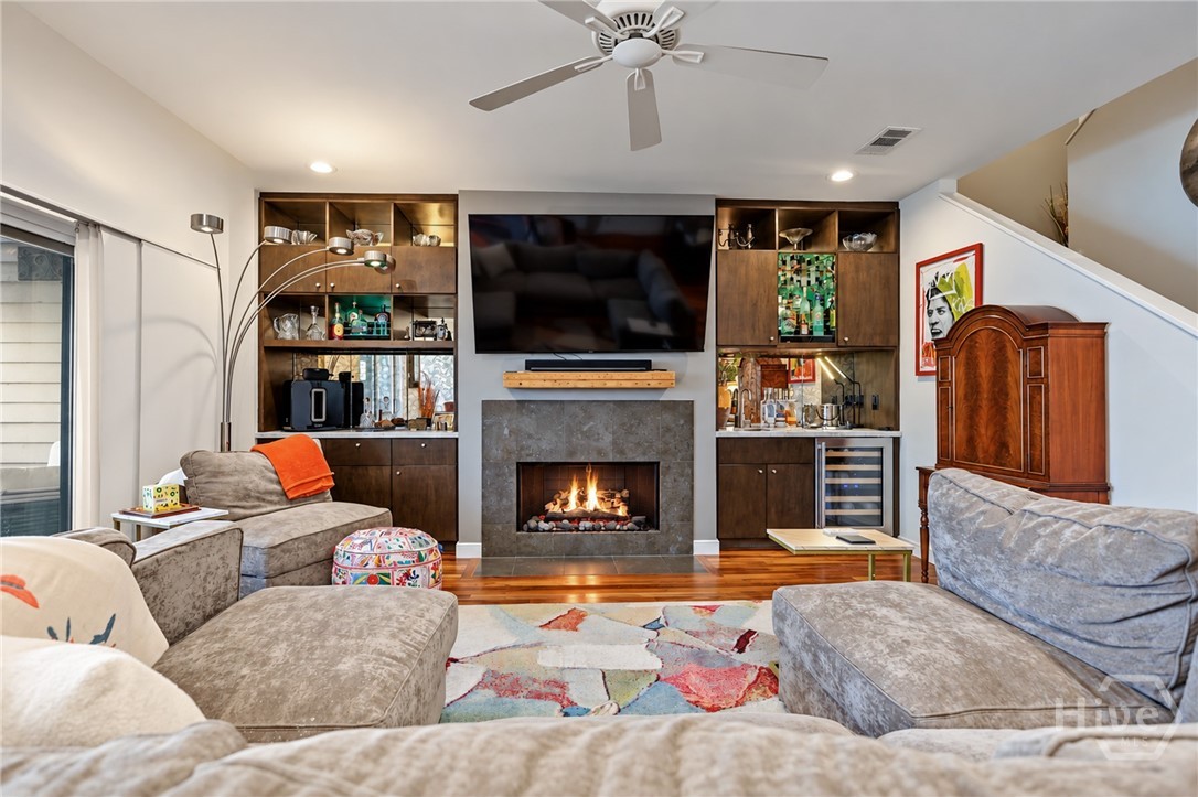 Living Area with custom lit and mirrored back built-ins.