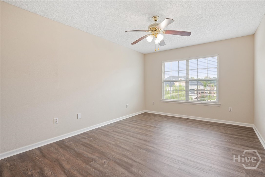 Lighted ceiling fan and walk-in closet.