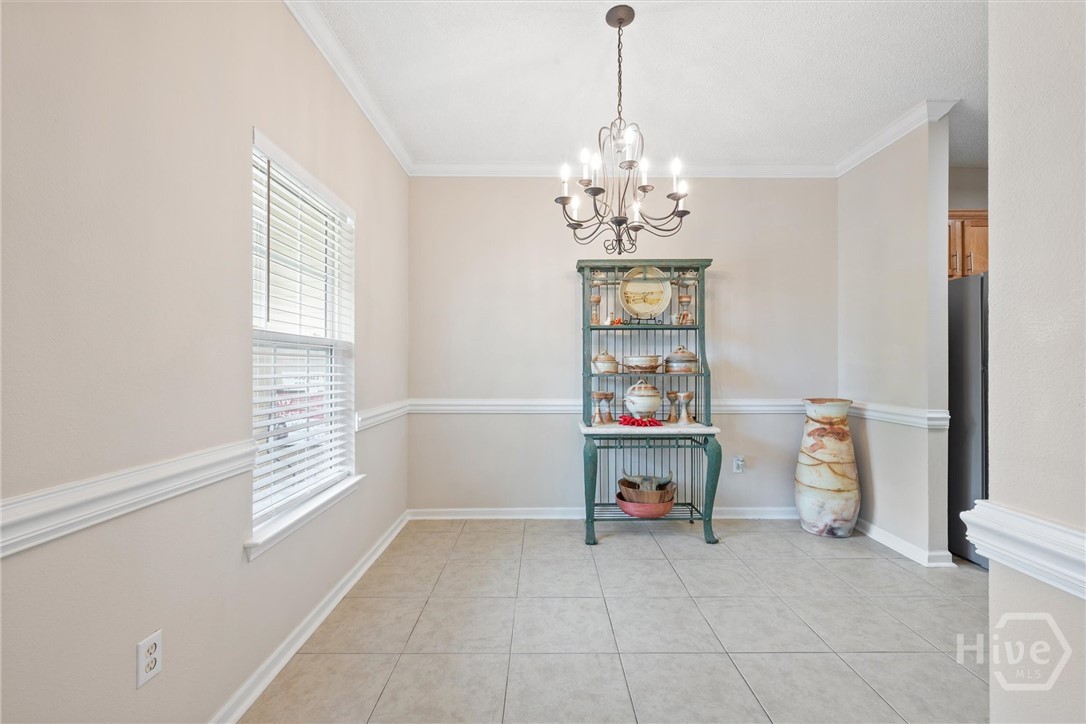 Dining room with chandelier lighting.
