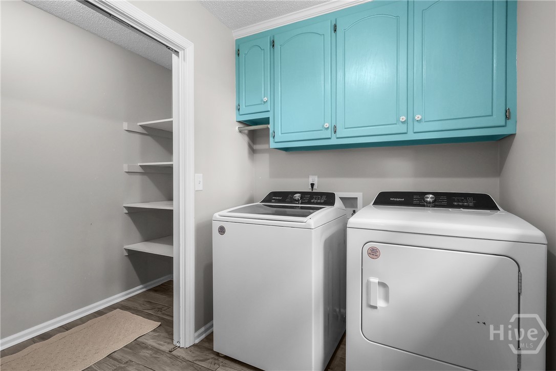 Large laundry off kitchen with additional storage