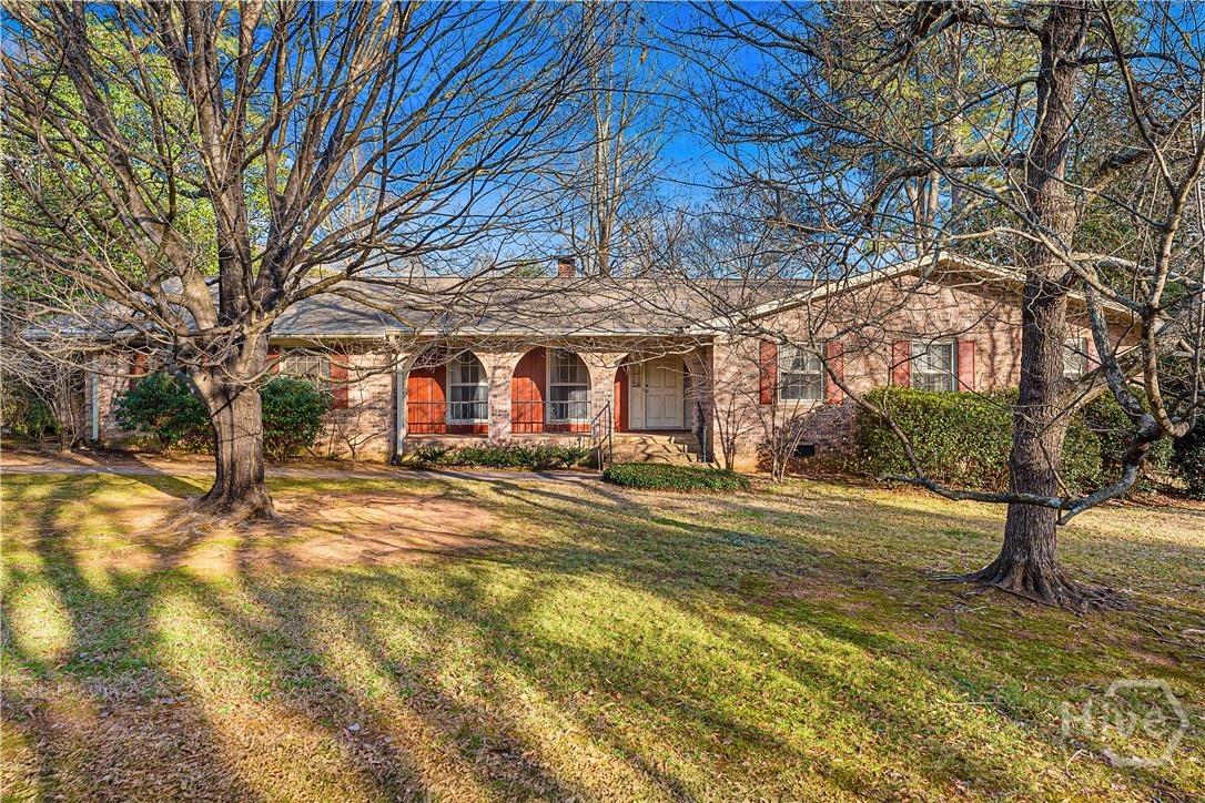 Location, location, location! Ideally situated in the prestigious Bedgood/Glenwood neighborhood, only 1.5 miles to the UGA Campus and a 10 minute walk to 5-Points shopping and dining. This four sided brick residence presents a rare opportunity in one of the area's most desirable settings. Architectural character shines through in the graceful curved lines of the front porch, offering subtle Southwestern influence and timeless curb appeal. With solid construction and enduring charm, this home provides the perfect canvas to thoughtfully update and tailor to your personal vision. This property is part of an estate and is being offered in its current condition (AS IS).