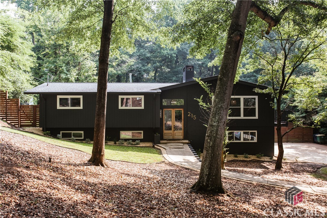 Gorgeous and updated midcentury modern home with a split foyer and massive gunite pool! Vaulted ceiling, exposed beams, and stacked stone fireplace in the Greatroom. Updated owner's suite bathroom features new, curbless tiled shower. The basement level was recently gutted and waterproofed. Fully fenced backyard, outdoor fireplace, and drive-under two car garage.
