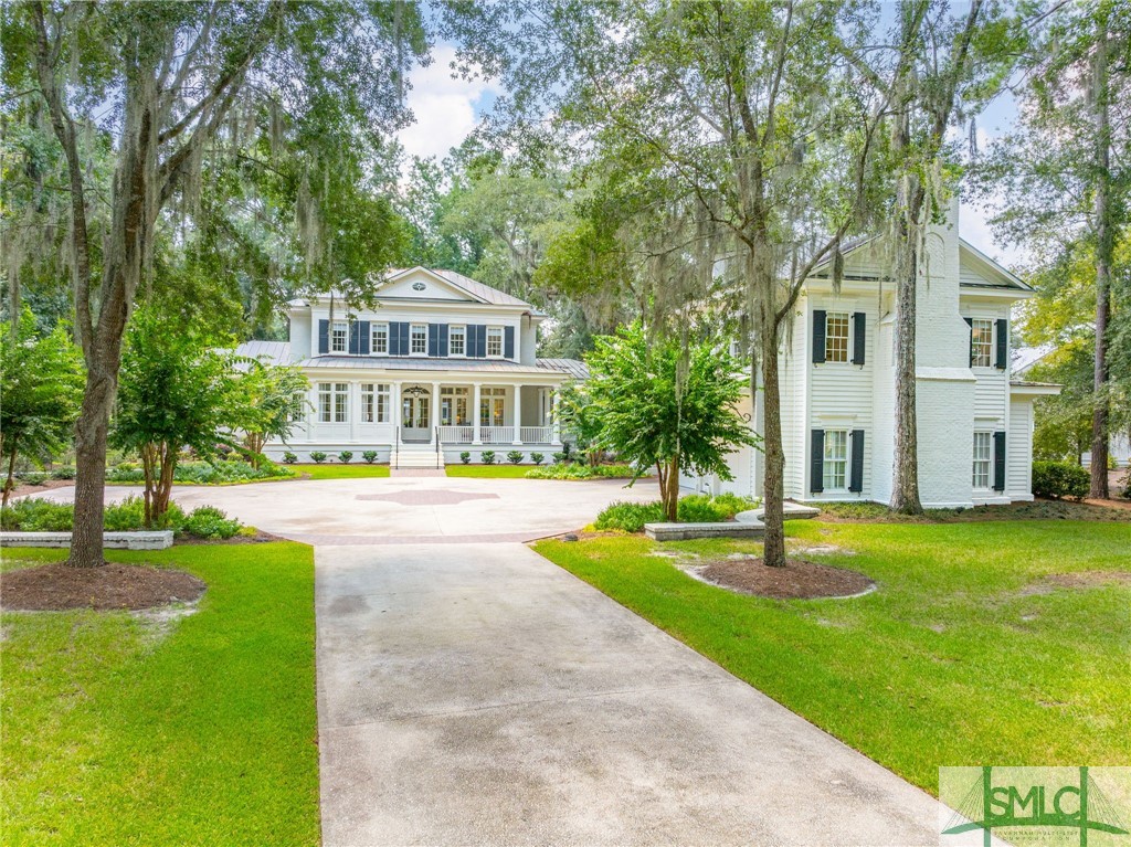 Nestled among majestic oaks draped with Spanish moss, this idyllic Lowcountry estate offers a serene escape on a private 1.23-acre lot at the Ford Field & River Club. With breathtaking views of the 2nd fairway of Pete Dye's award-winning golf course and the tranquil Lake Savage, this property is a true gem. The estate includes both a beautifully renovated main house and a spacious carriage house, each meticulously updated from top to bottom. The gourmet kitchen is a chef's dream, featuring Miele and Subzero appliances, custom Porada cabinetry, and a well-appointed butler's pantry. The main house boasts master suites on both the main and second floors, each with luxurious custom closets, fine art lighting, and elegantly updated ensuite bathrooms. Motorized blinds throughout. Take advantage of year-round outdoor living and incredible views from the front and back porches. Located 20 minutes south of downtown Savannah, GA, this estate combines the best of refined living & natural beauty.