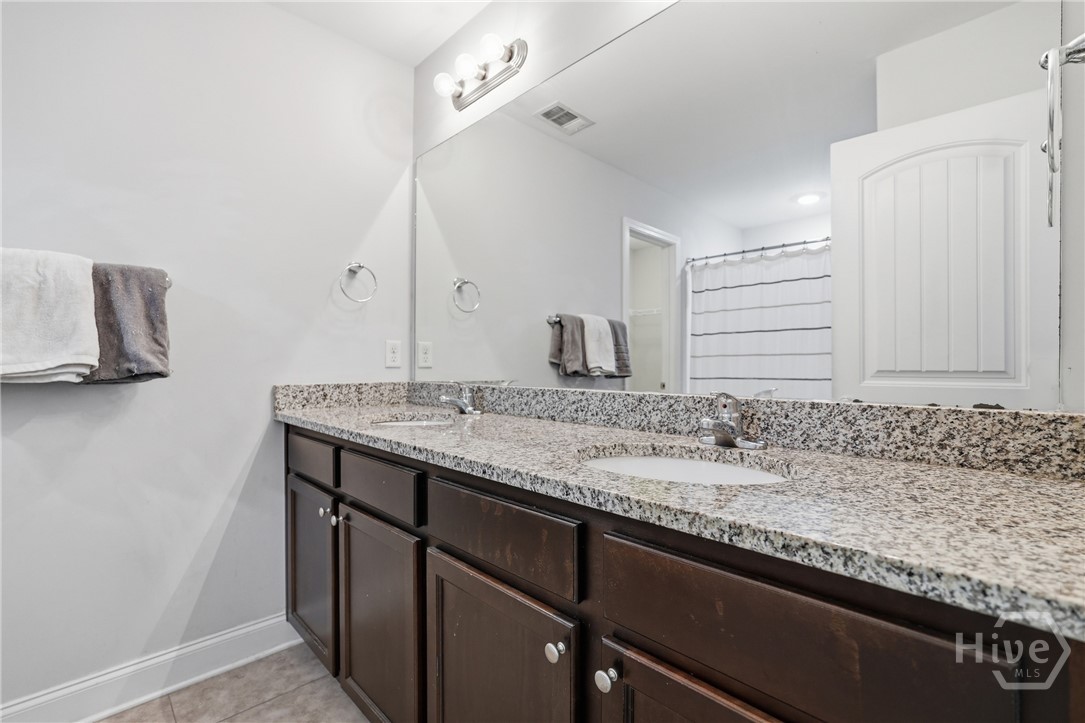 Primary bathroom offers plenty of storage and beautiful cabinets.