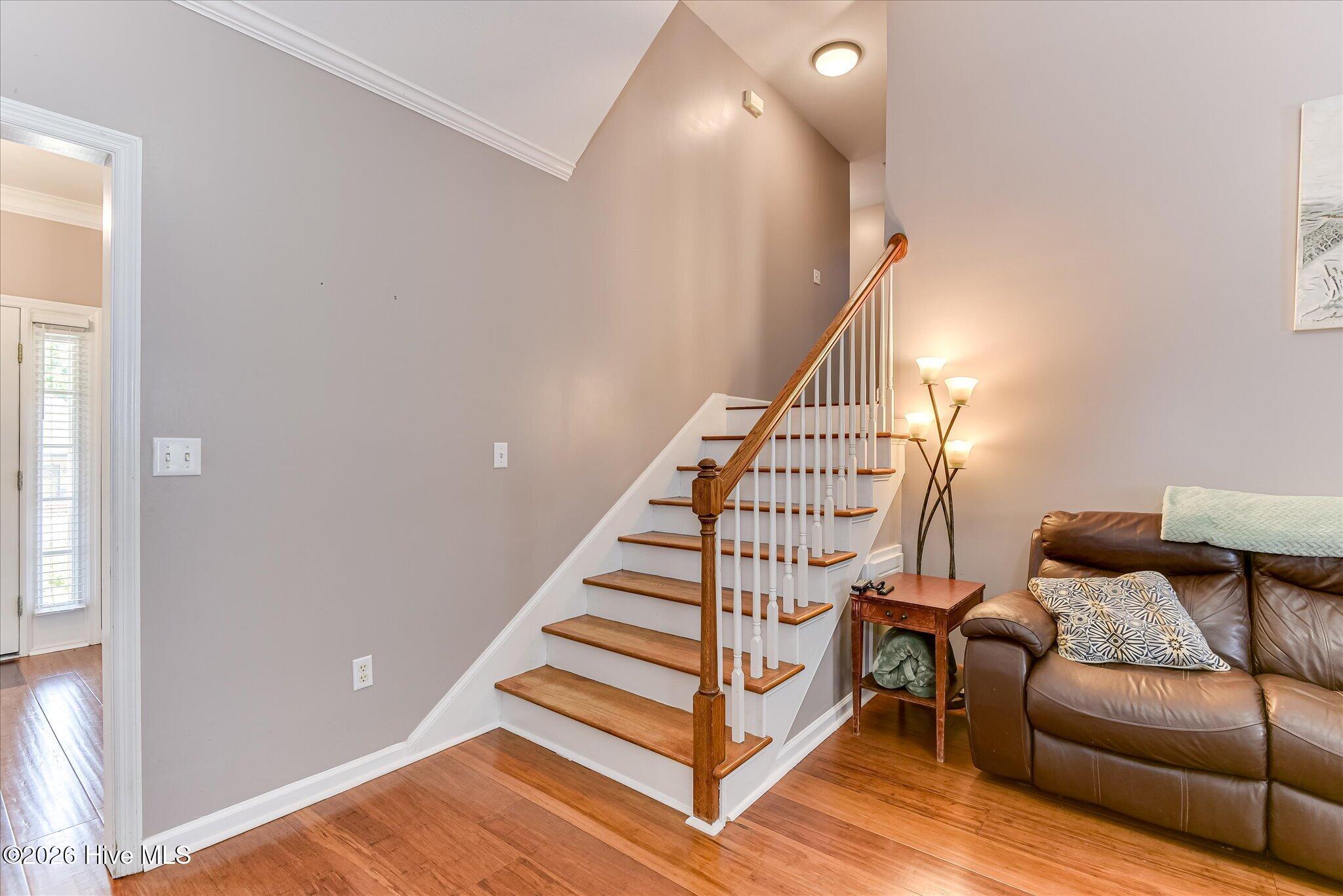 Half flight stairs leading from main floor to primary bedrooms and laundry