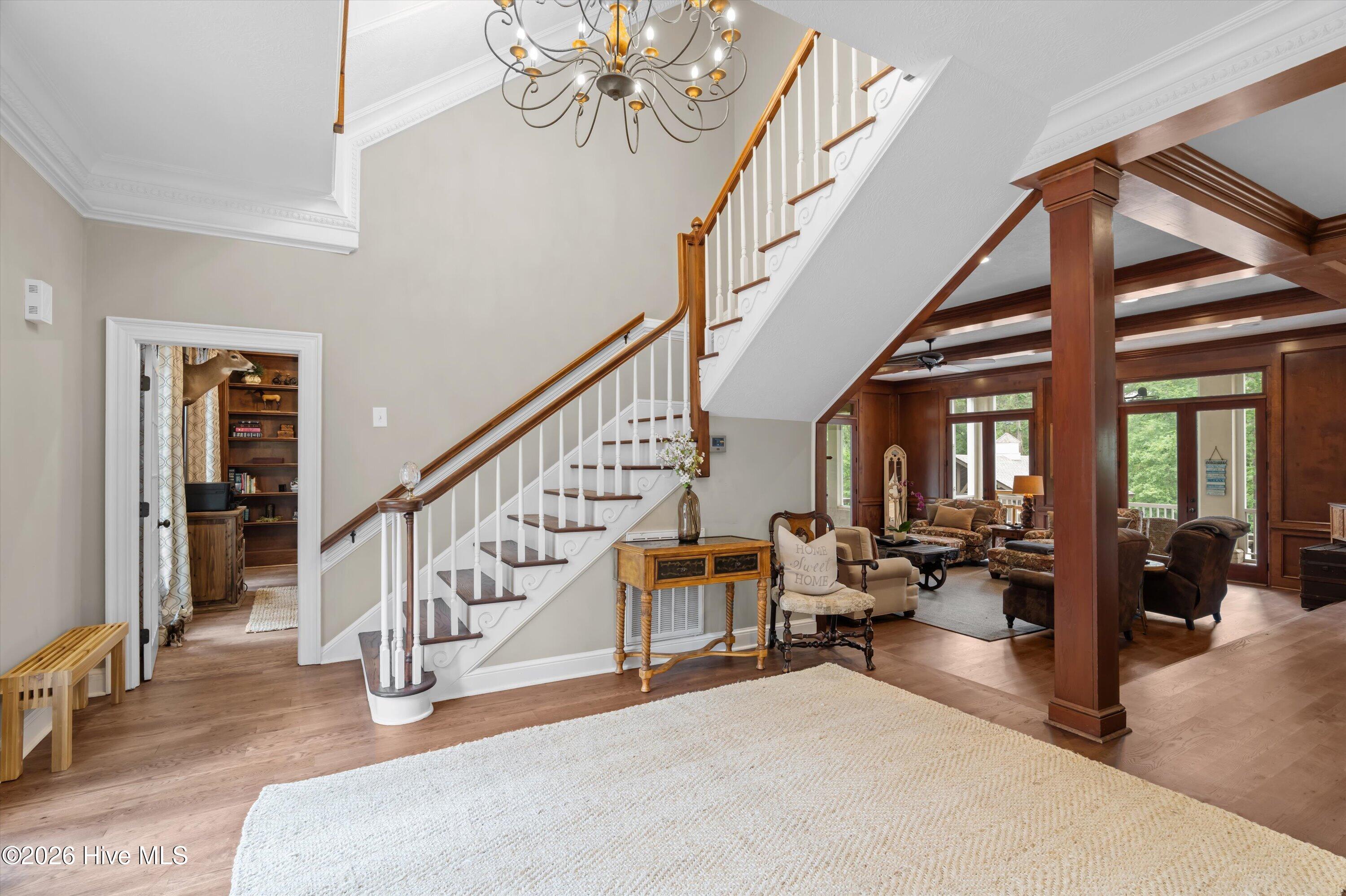 Foyer opens to living room and is flanked by office and formal dining room.