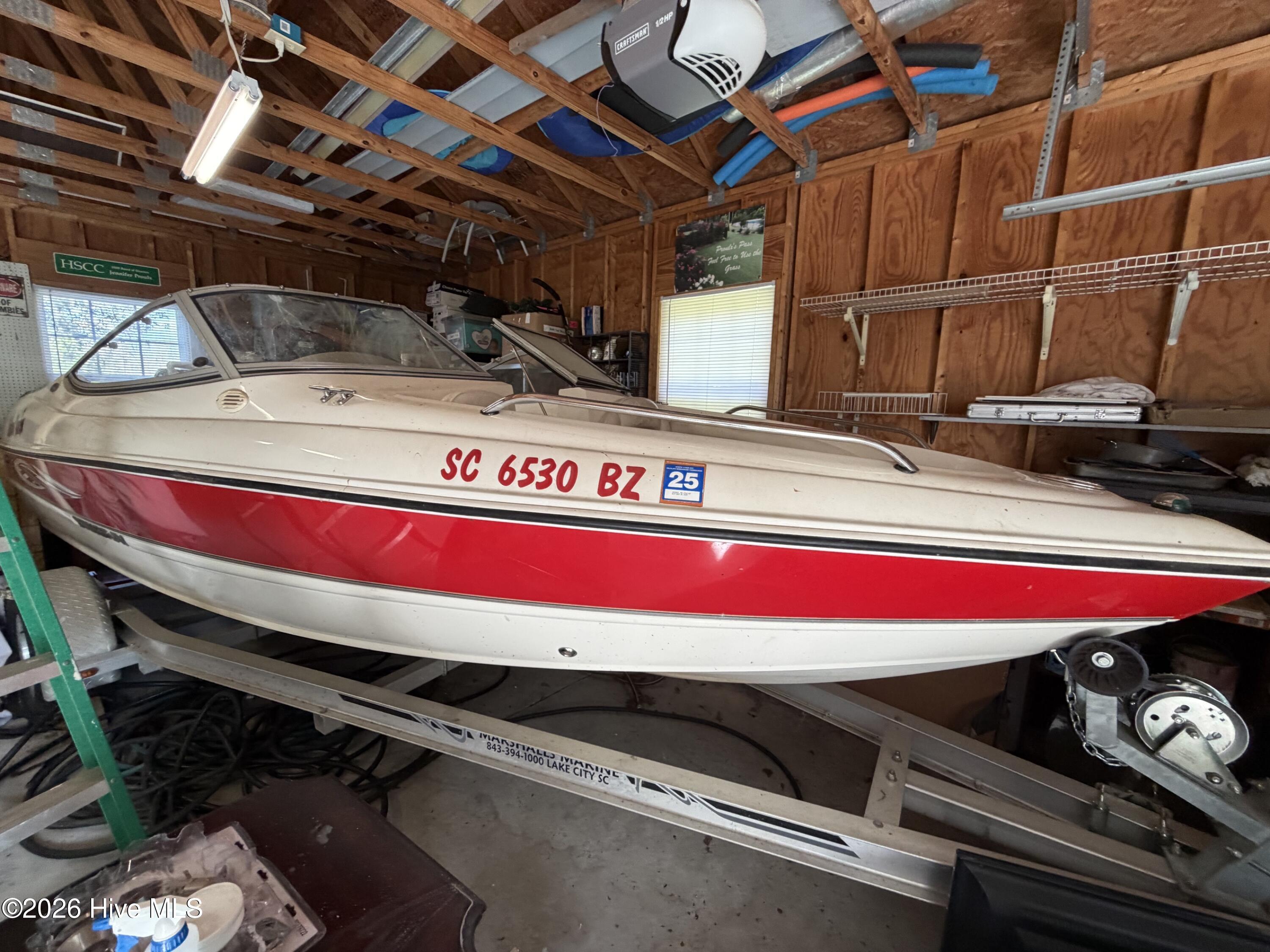 Garage is detached two-stall with room for this 18' boat