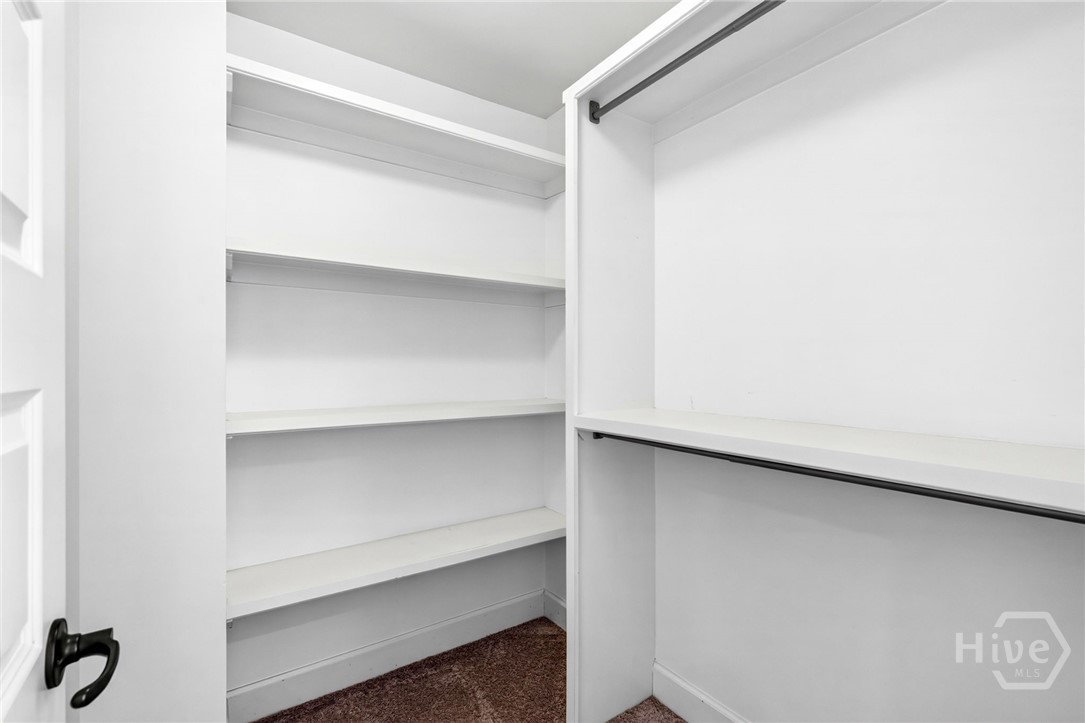 walk-in closet with custom shelving in all 3 bedrooms