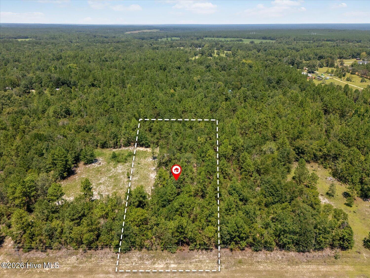 Elevated aerial view of the property and surrounding area