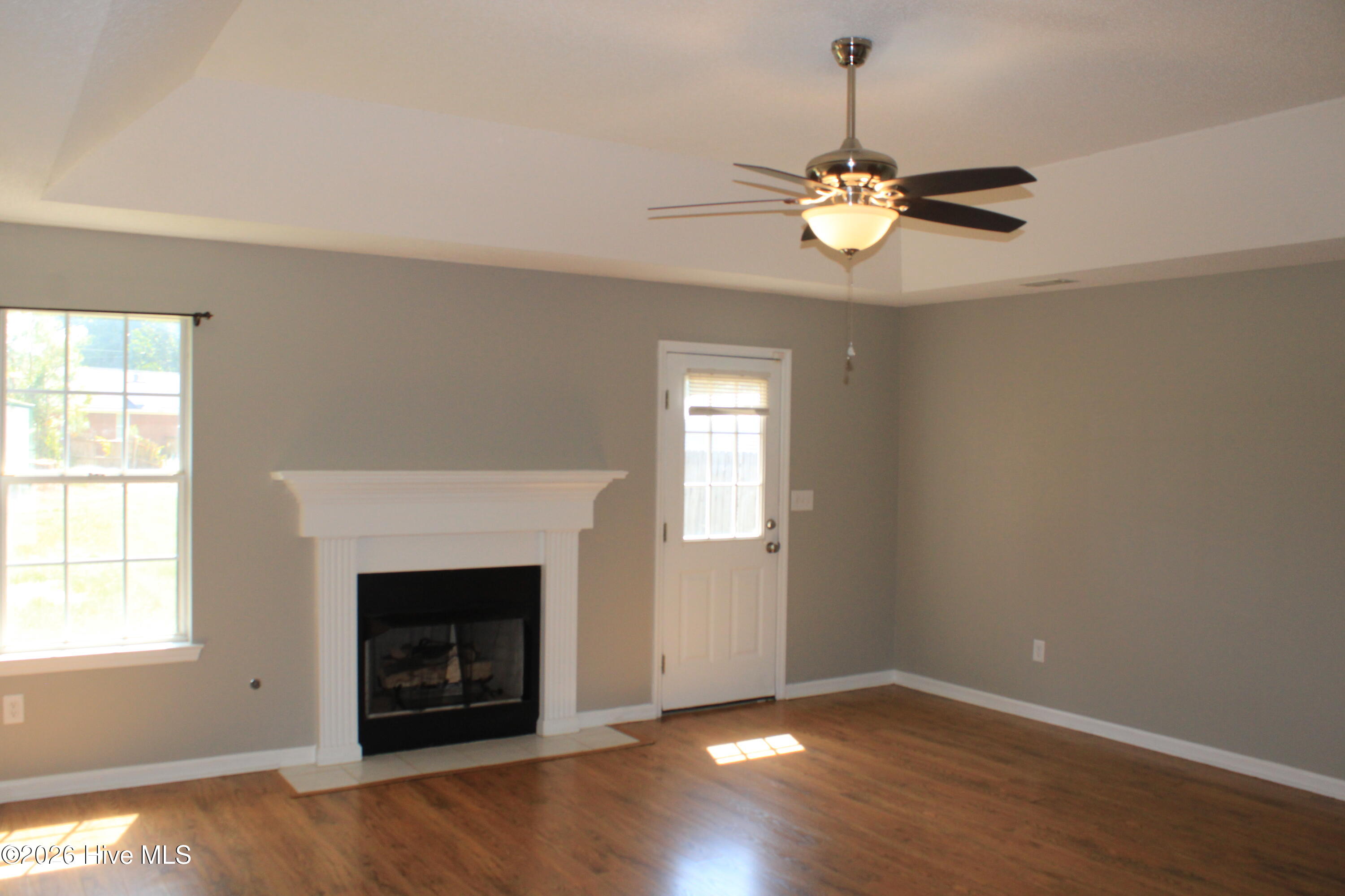 Laminate wood flooring and gas fireplace.