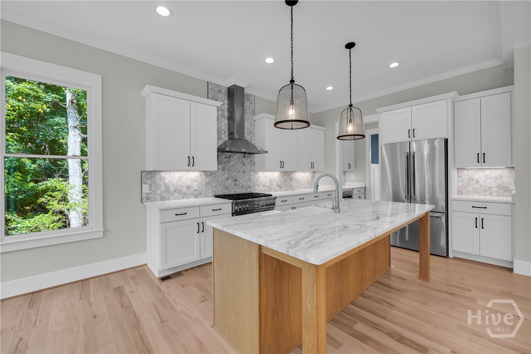 Stunning chef’s kitchen featuring marble and quartz countertops, a complete Thermador stainless steel appliance package, 5-burner natural gas cooktop, dedicated coffee station, and an impressive butler’s pantry for added storage and entertaining convenience