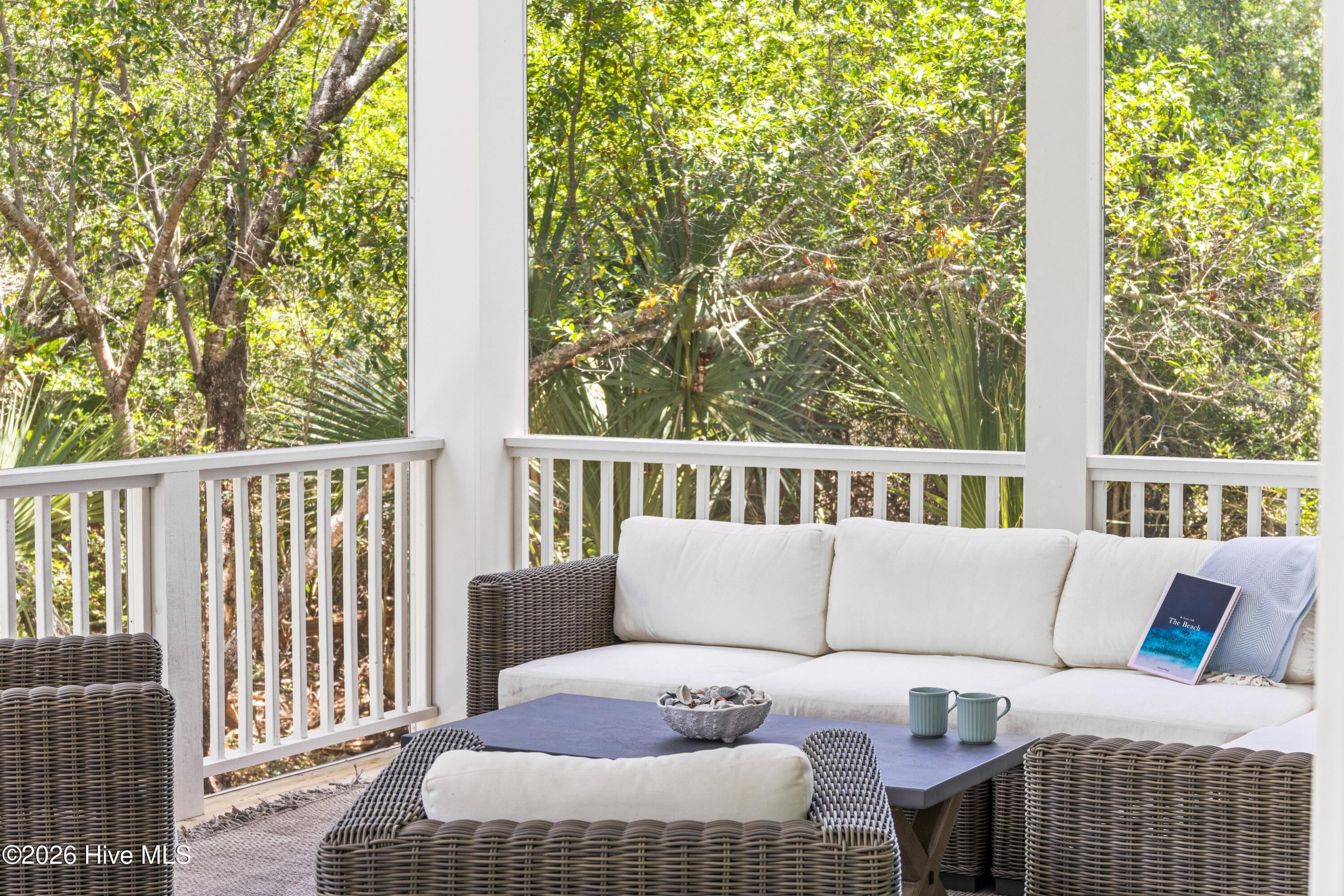 Screened-in porch with dining and seating areas