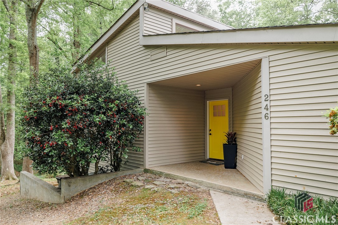 Bathed in natural light and brimming with character, this stunning mid-century lodge with a saltwater pool offers a rare blend of architectural beauty and peaceful, park-like surroundings. From the vaulted ceilings and clerestory windows to the whitewashed tongue-and-groove detailing and dramatic floor-to-ceiling stone fireplace, the living spaces feel open, inviting, and effortlessly stylish.The heart of the home is the renovated kitchen—thoughtfully designed with sleek black granite countertops, warm wood cabinetry, new stainless steel appliances, and an abundance of storage. There's even a dedicated workspace tucked in, perfect for managing busy days from home.With four spacious bedrooms and three and a half baths, there’s room for everyone to spread out. Three bedrooms are located on the main floor, each with sliding doors that open to the serene outdoors. Downstairs, the light-filled terrace level includes a second living area with a convenient kitchenette/bar—ideal for guests, entertaining, or just relaxing by the pool. Speaking of the pool: it's saltwater, newly updated with a fresh liner and loop-lock cover, and just steps from a charming gazebo. Your own private backyard oasis for warm Georgia summers.All of this is set against the backdrop of Bear Creek flowing gently behind the property. The natural beauty continues just beyond the property line, where the 34-acre Robert L. Bridges Park offers walking trails and a Boy Scout-built wooden bridge leading to the Treadwell Trail—right next door. Your backyard feels like a private nature preserve, permanently protected from development.With a new roof, new water heater, new appliances, and thoughtful upgrades throughout, this home is truly turnkey and move-in ready. And the location couldn’t be more convenient—less than a mile to downtown Statham, just 16 miles to Athens, and only 8 miles to Winder.A rare opportunity to own a home that offers comfort, character, and a seamless connection to nature.