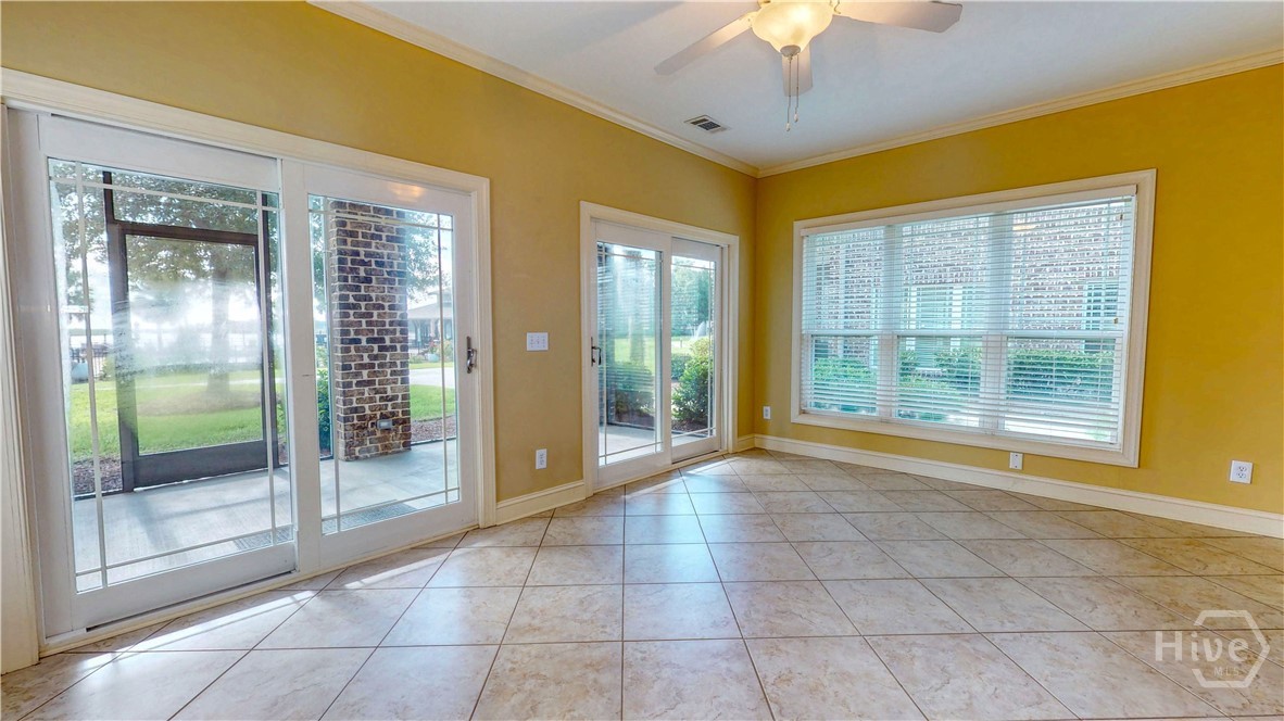 Sunroom looking out to the screened in porch and the river