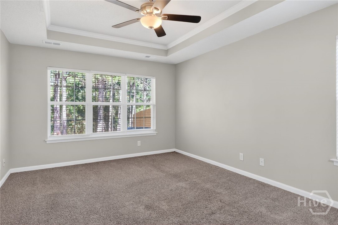 Primary bedroom with tray ceiling
