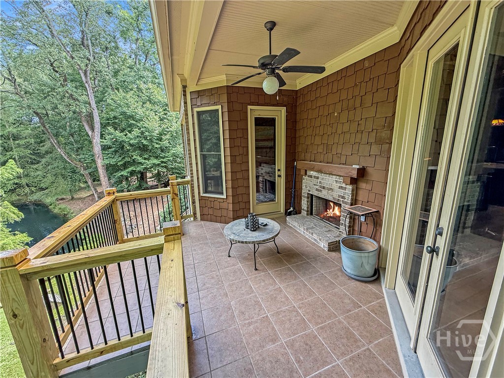 Back Porch partially covered with fireplace and doors from the Great Room and Master Bedroom