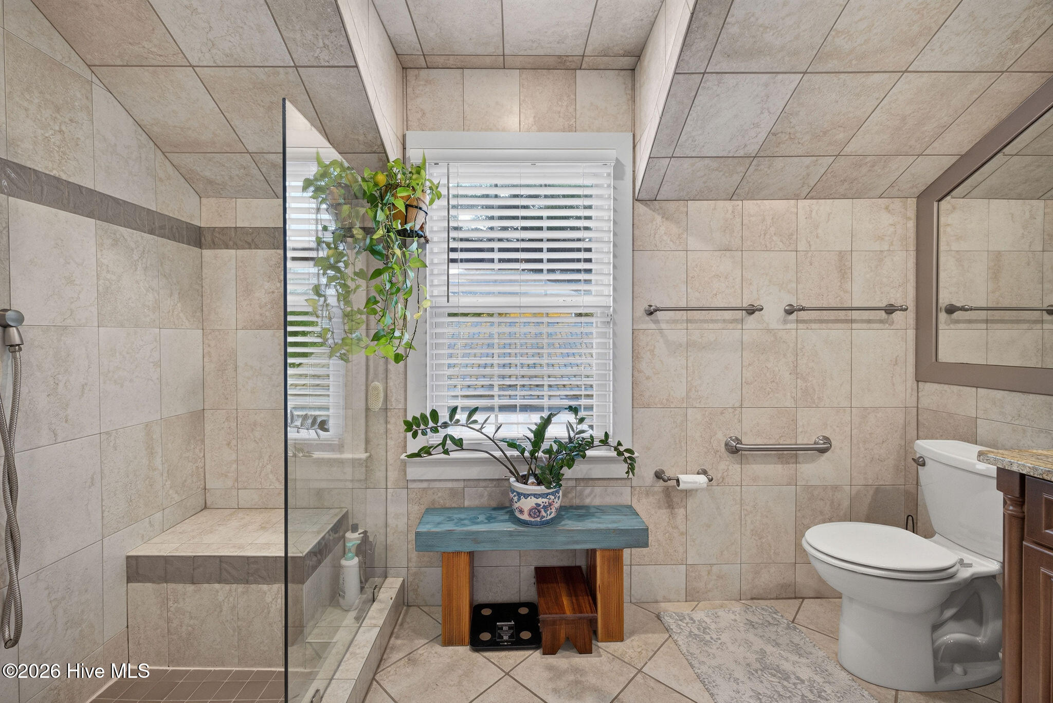Upstairs fully updated bathroom with walk-in tiled shower